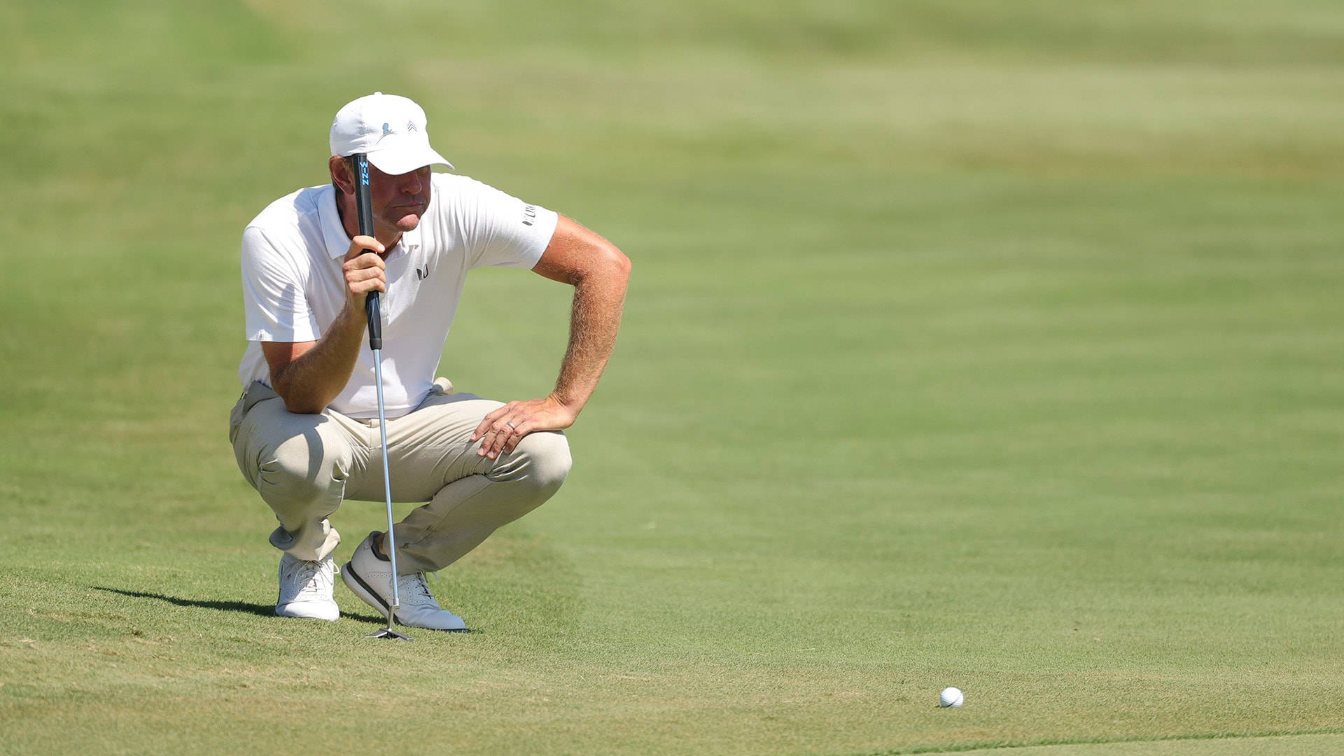 Golfer Lucas Glover Reflective On The Golf Course Background