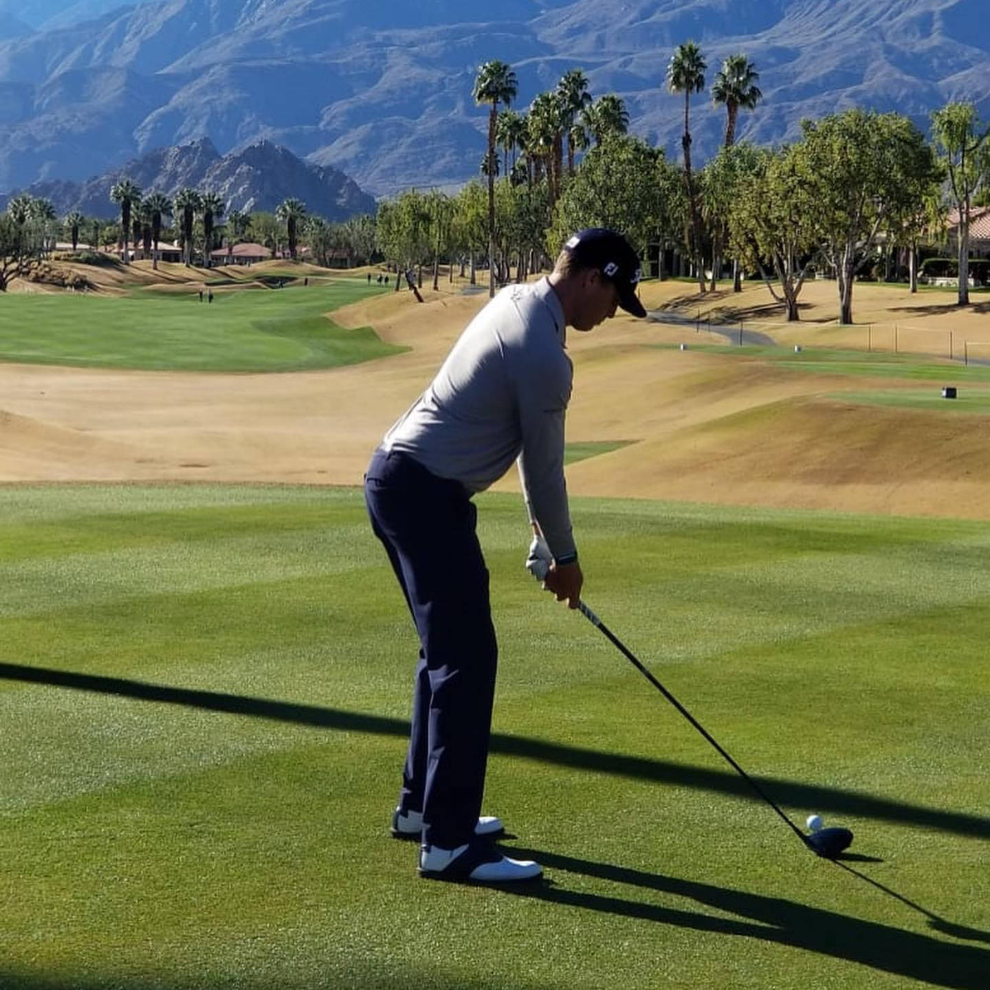 Golfer Preparingfor Driveon Sunny Course Background