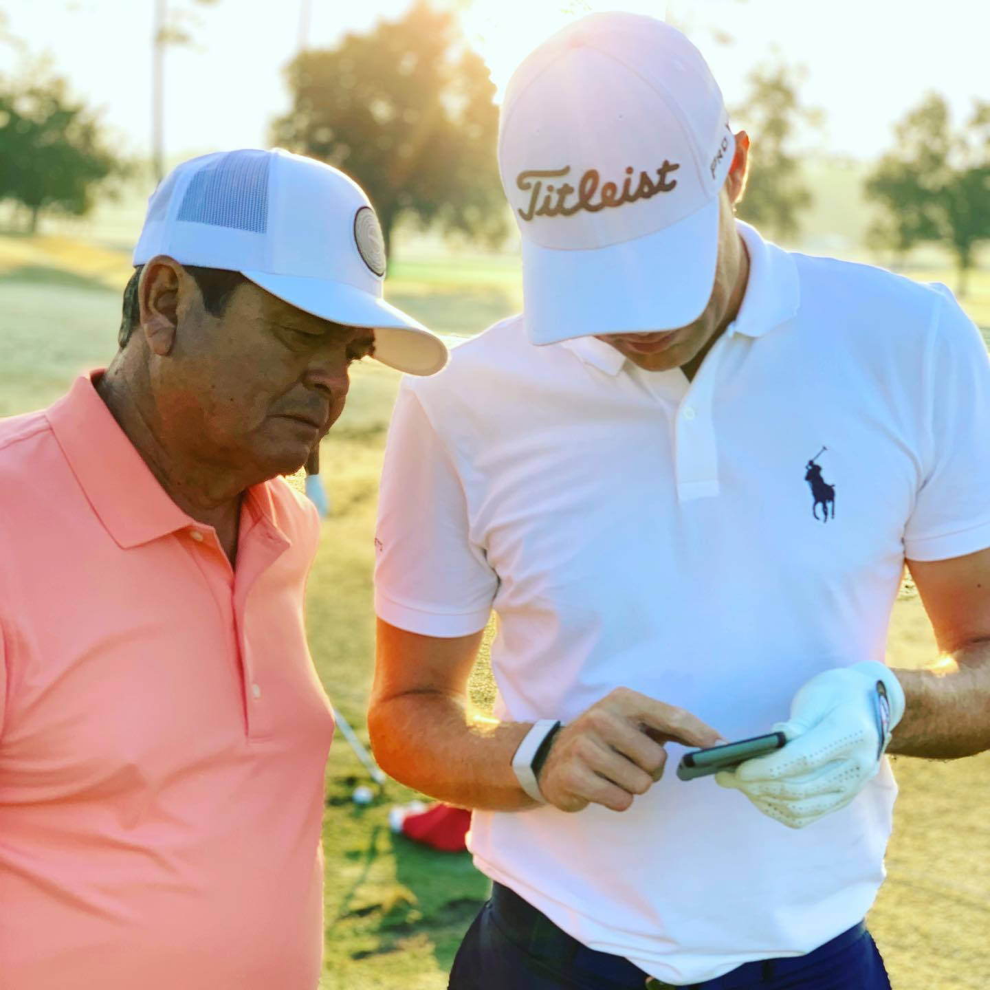 Golfers Reviewing Scoreon Phone Background