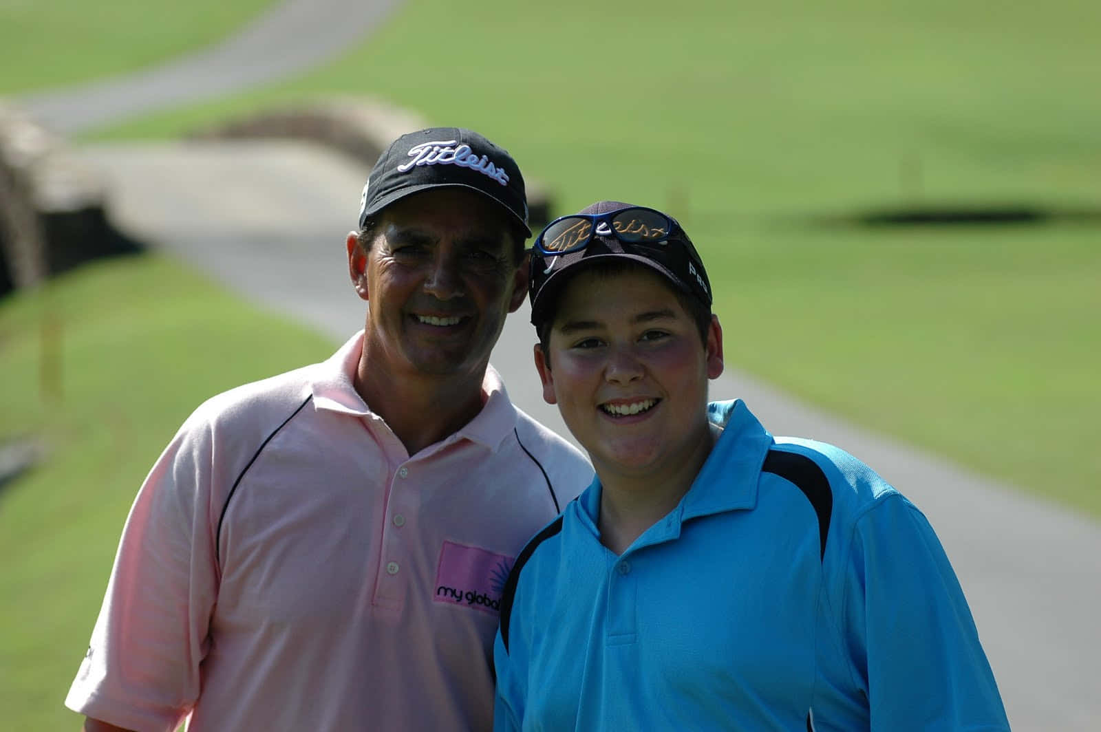 Golfers Smiling On Green Course Background