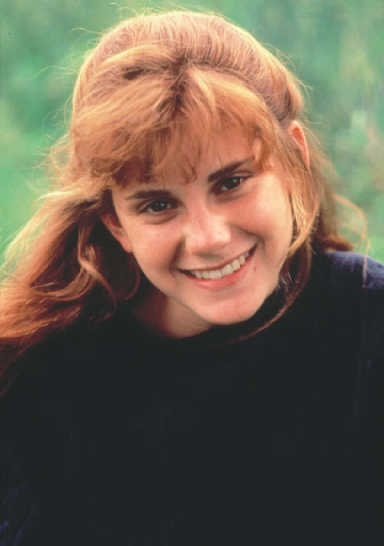 Goonies Cast Member Smiling Outdoors Background