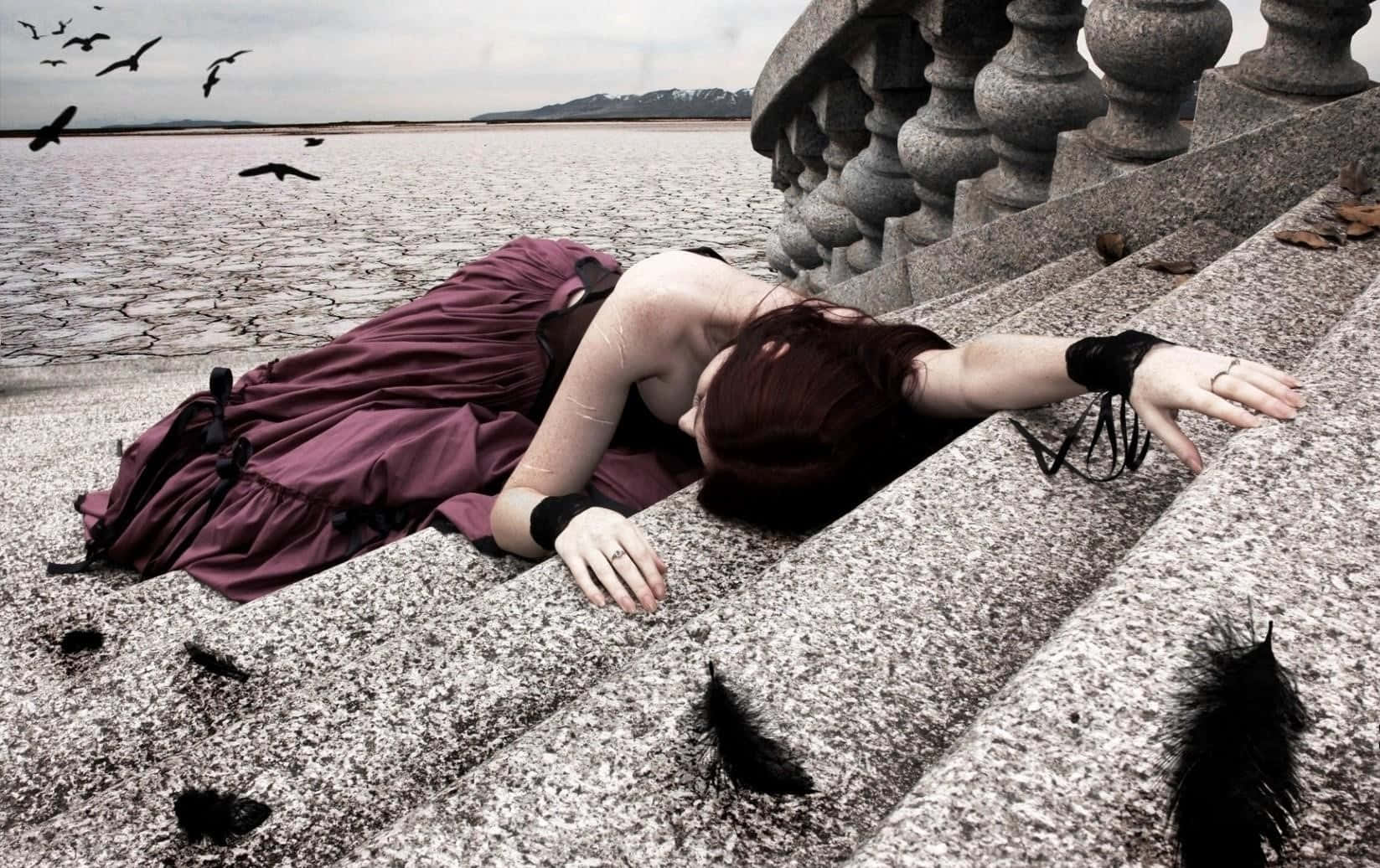 Goth Woman Profile Lying On Stairs Background