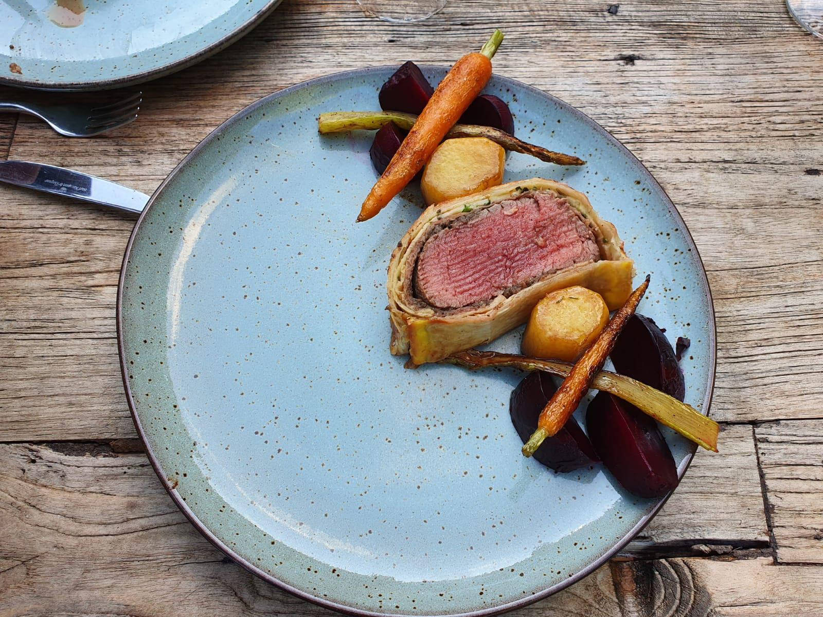 Gourmet Beef Wellington Served With Flavorful Roasted Carrots