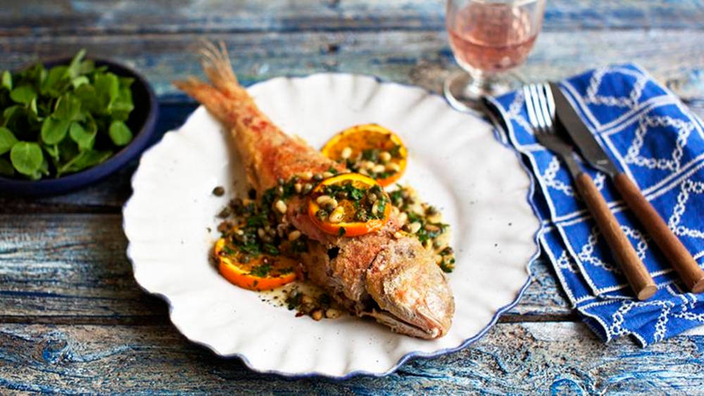 Gourmet Fried Red Mullet With Orange Background