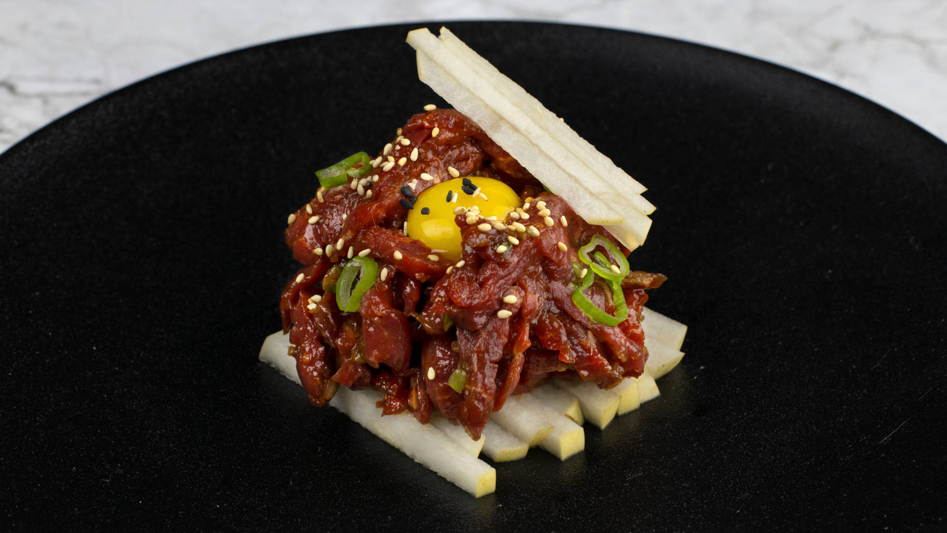 Gourmet Steak Tartare Dish With Spices And Accompaniments Background