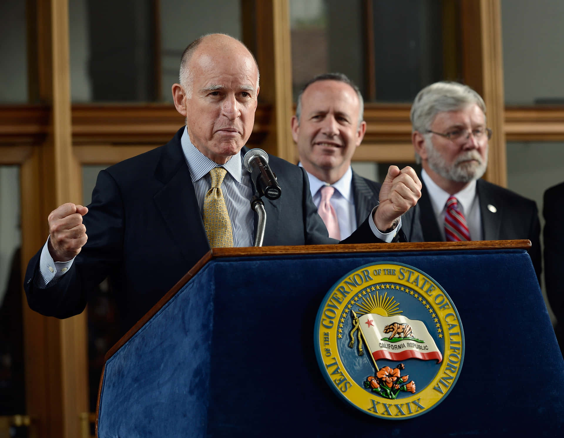 Governor Jerry Brown Excitedly Celebrates A Victory Background