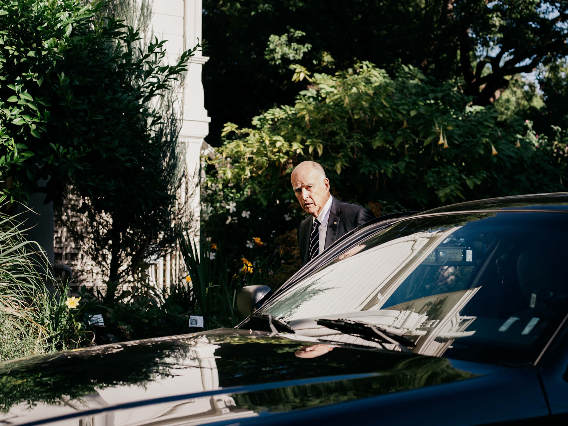 Governor Jerry Brown Of California Getting Out Of His Car Background