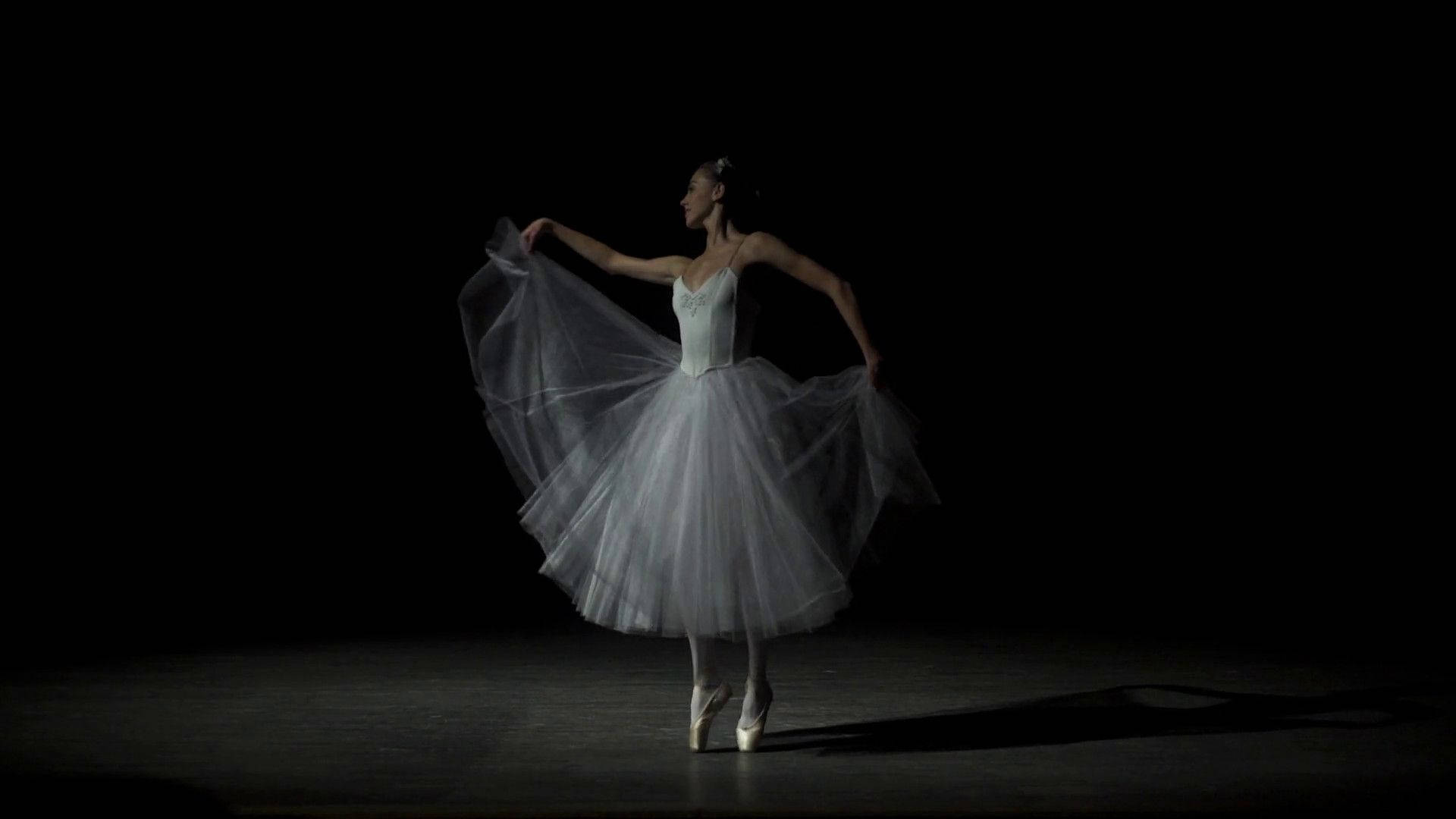 Graceful Asian Ballerina In Mid-dance Pose Background