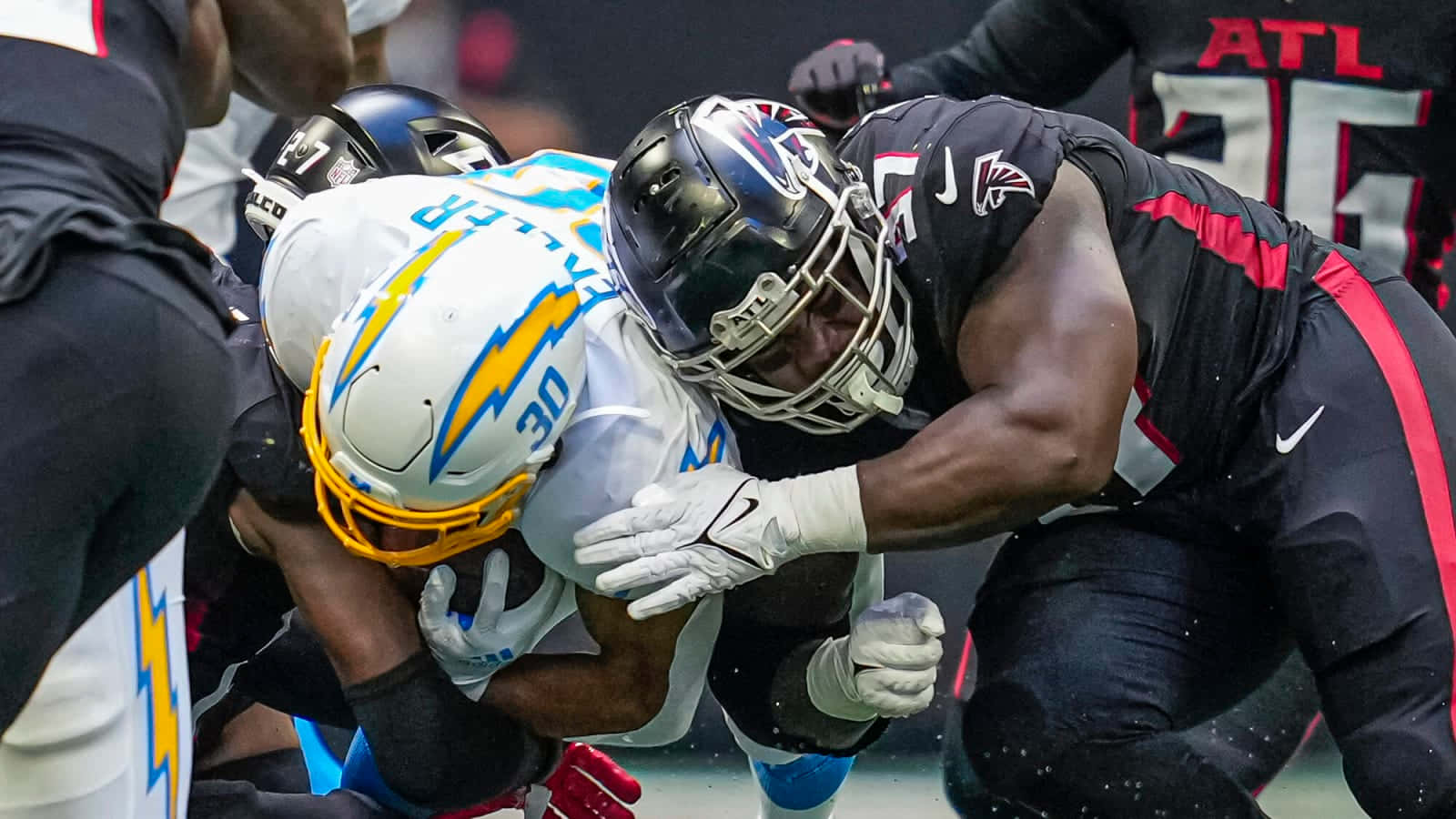 Grady Jarrett Showcasing Exceptional Football Skills Background