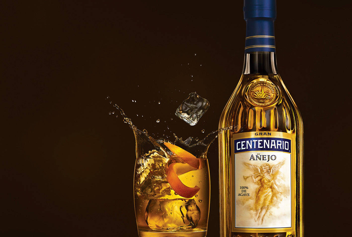 Gran Centenario Tequila Añejo Splashing On Glass Background