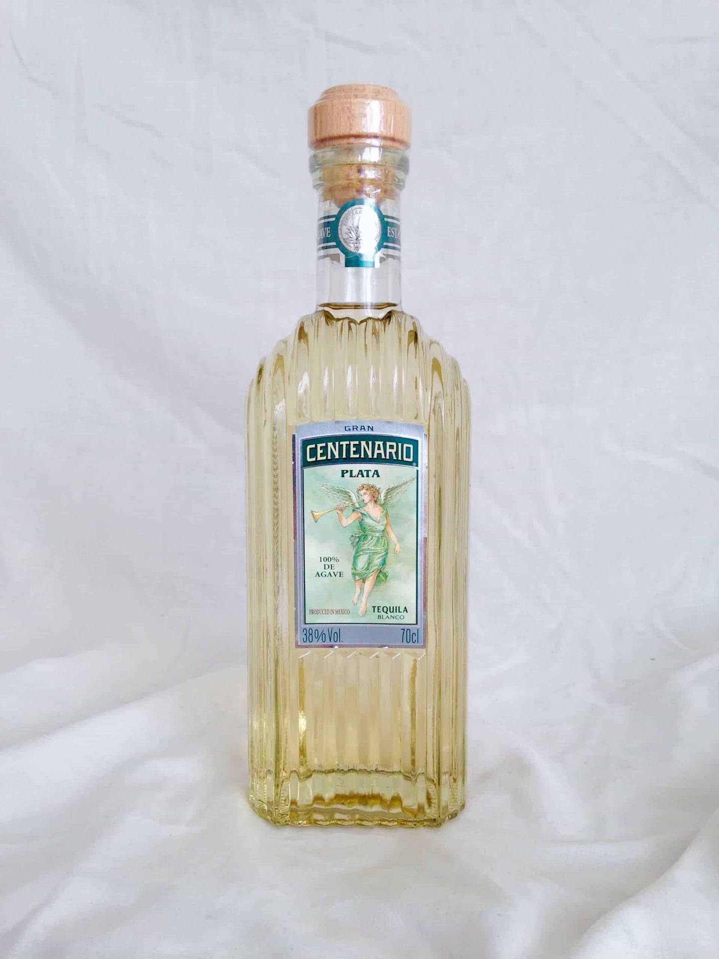 Gran Centenario Tequila Plata On White Cloth Background