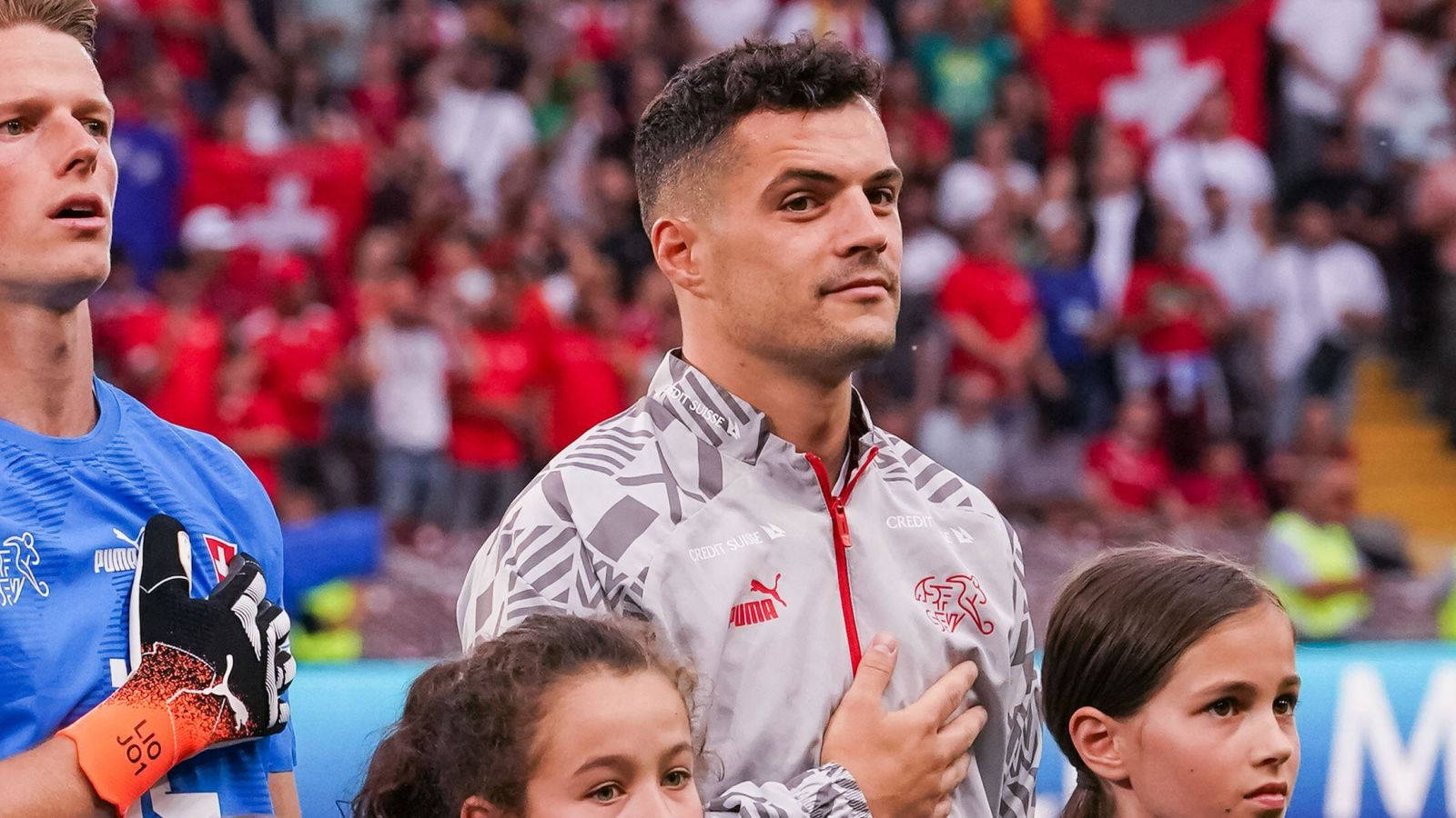 Granit Xhaka Next To Children Background