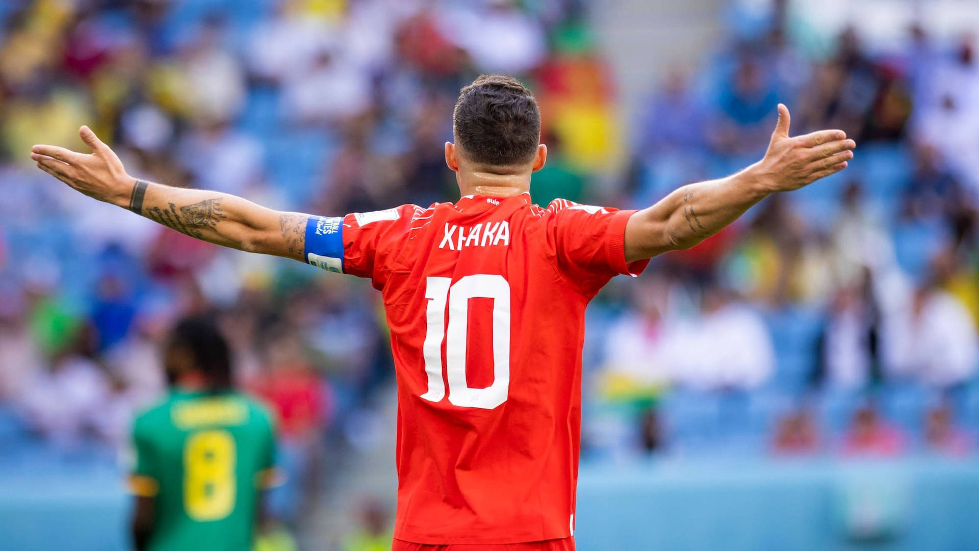 Granit Xhaka With Spread Arms Background