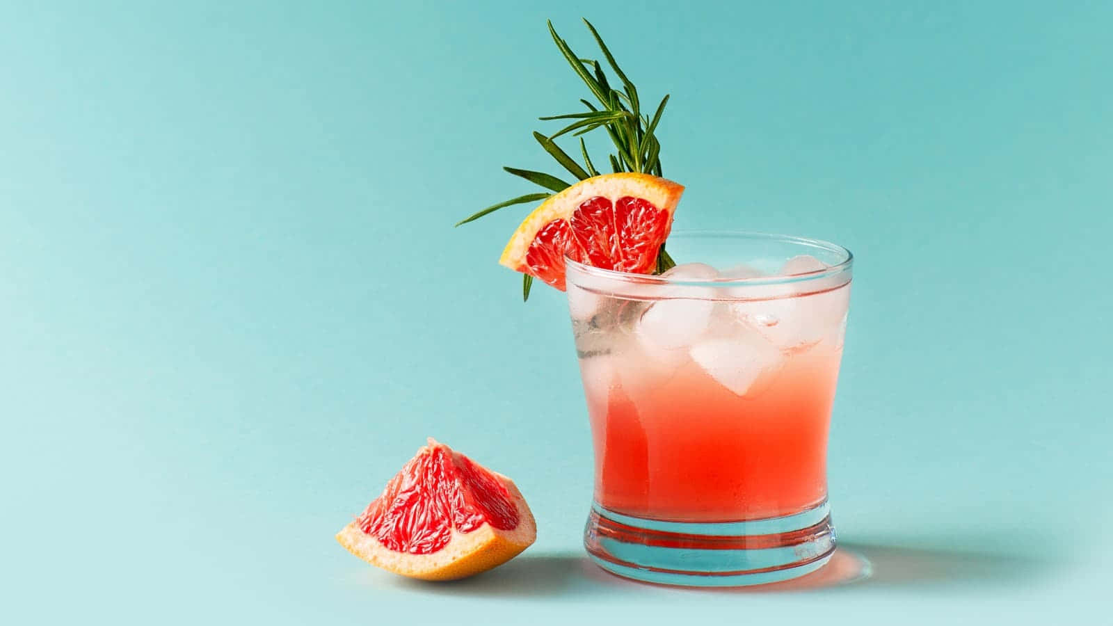 Grapefruit Drinks On Shot Glass Background