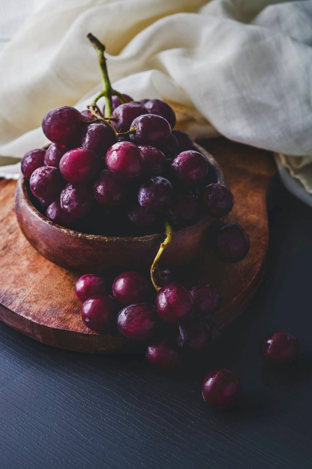 Grapes On Wooden Bowl Background