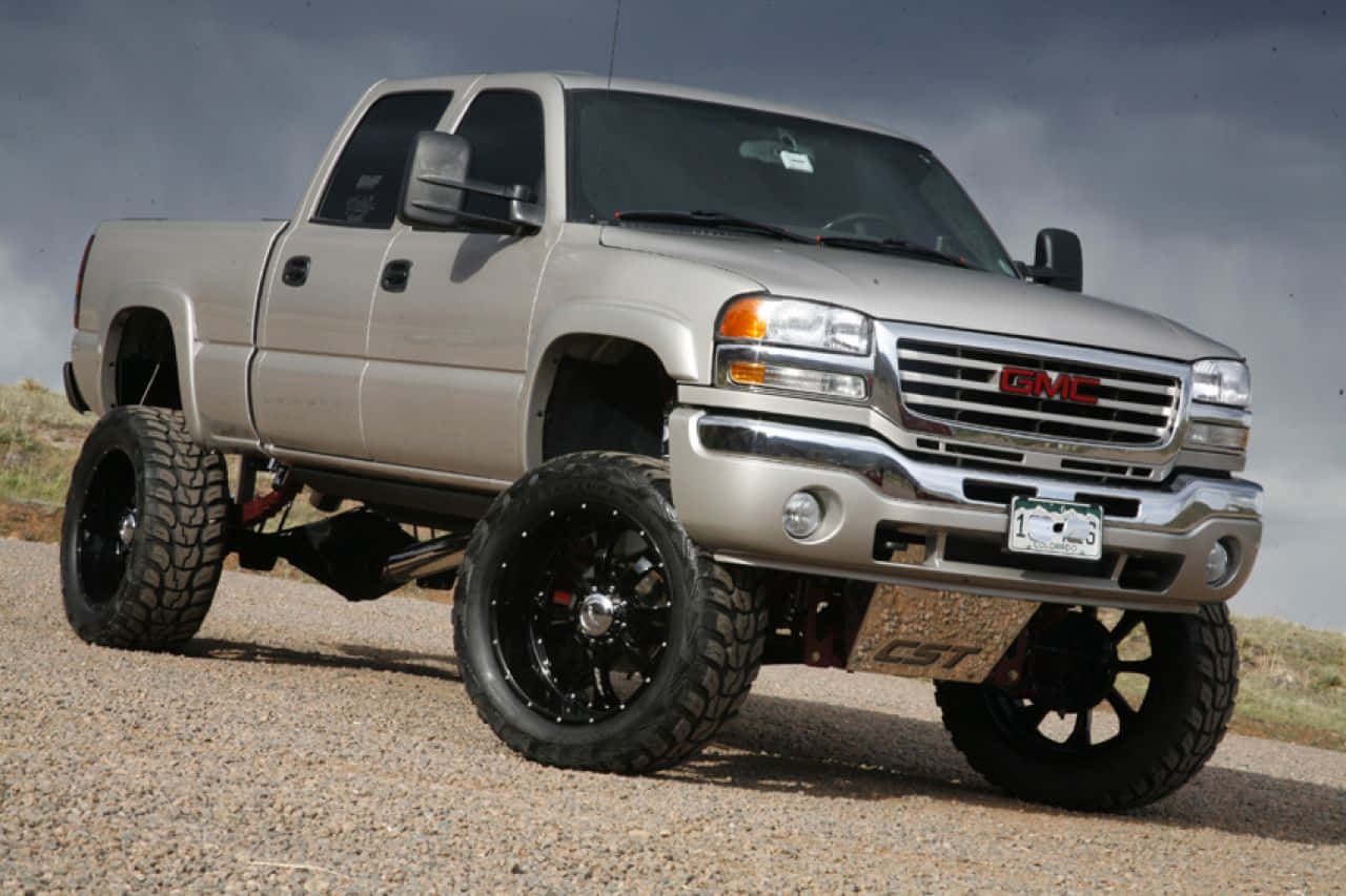 Gray Jacked Up Trucks In The Desert Background