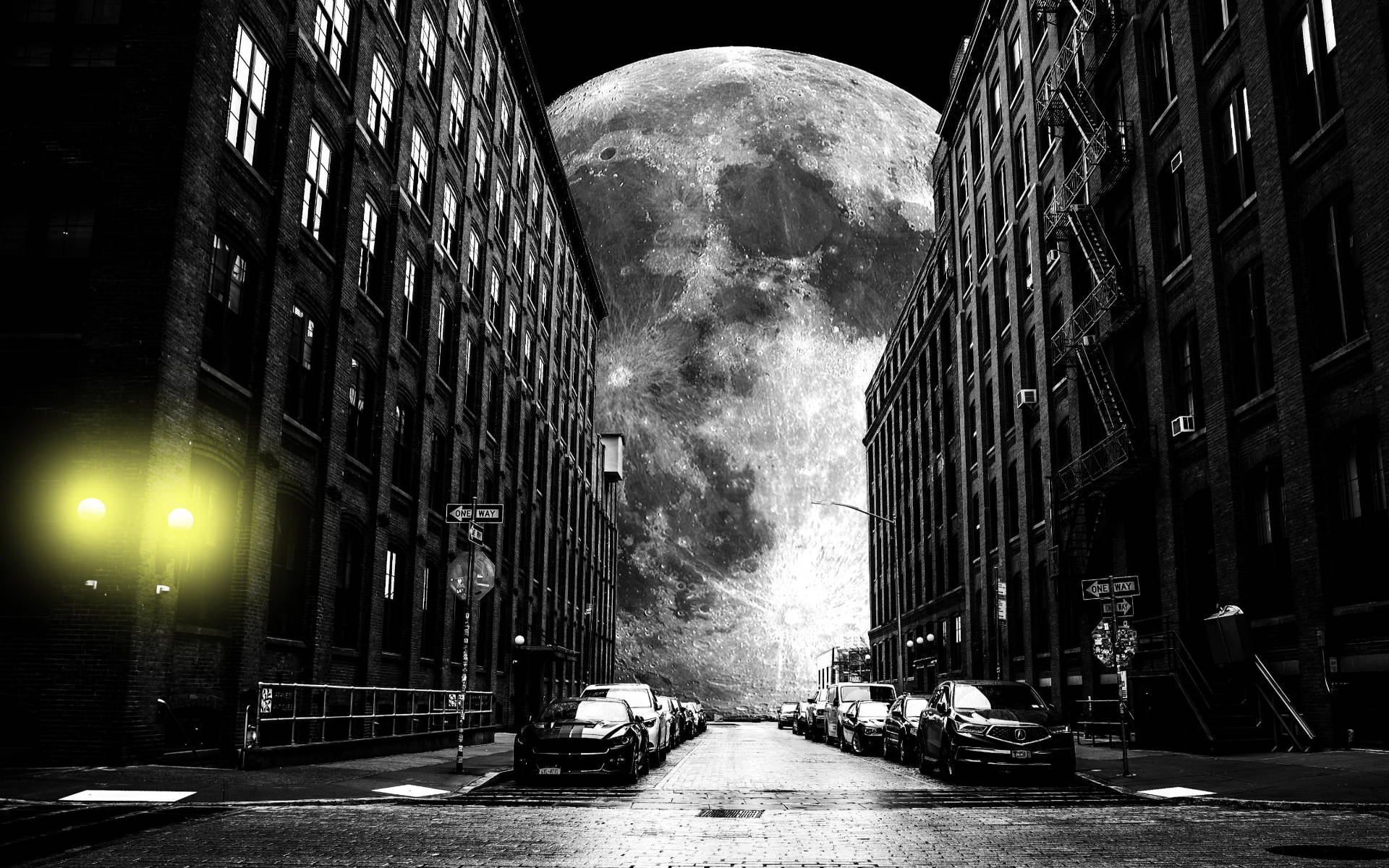 Grayscale Galaxy Moon Behind Buildings Background