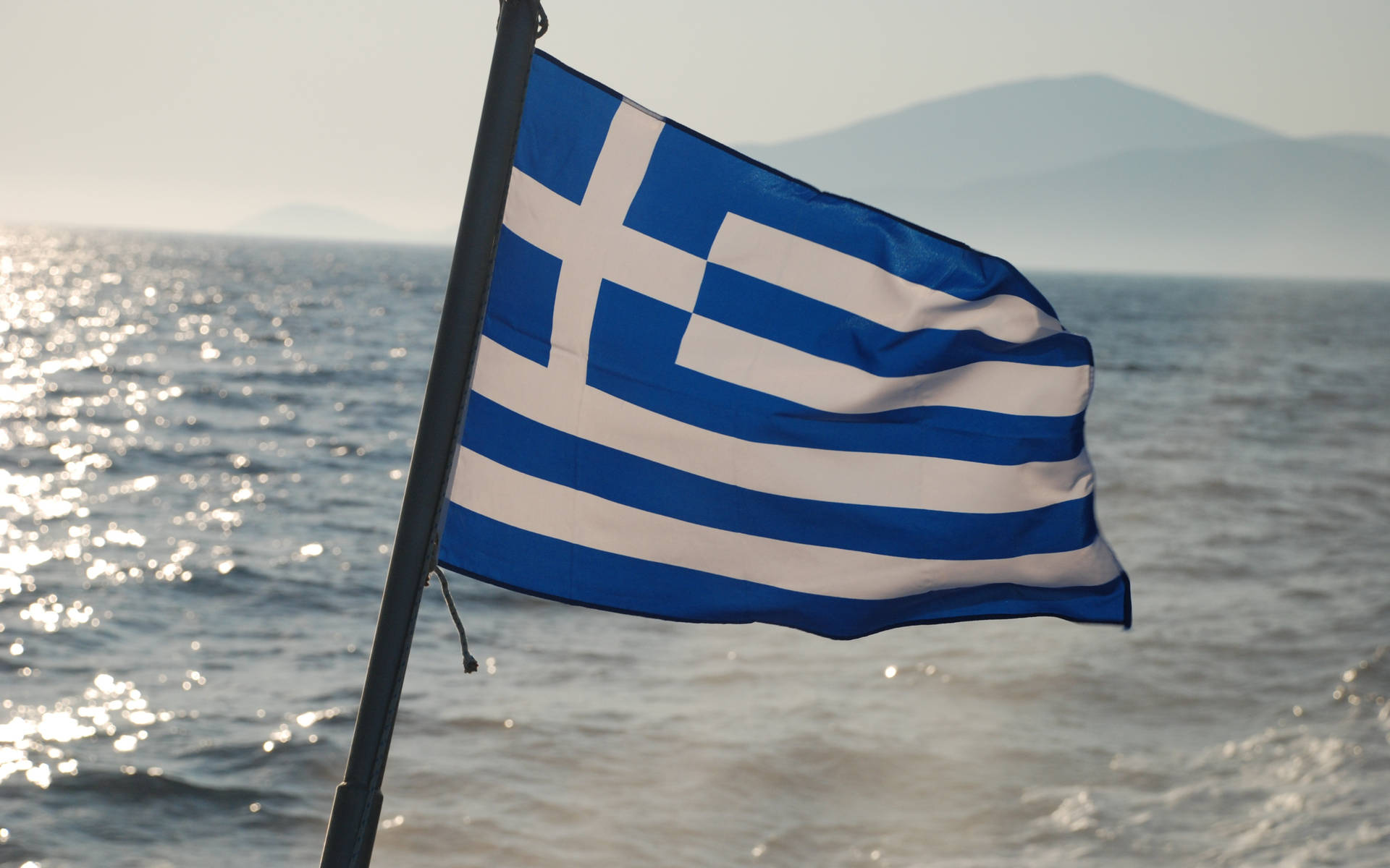 Greek Flag At Beach Background