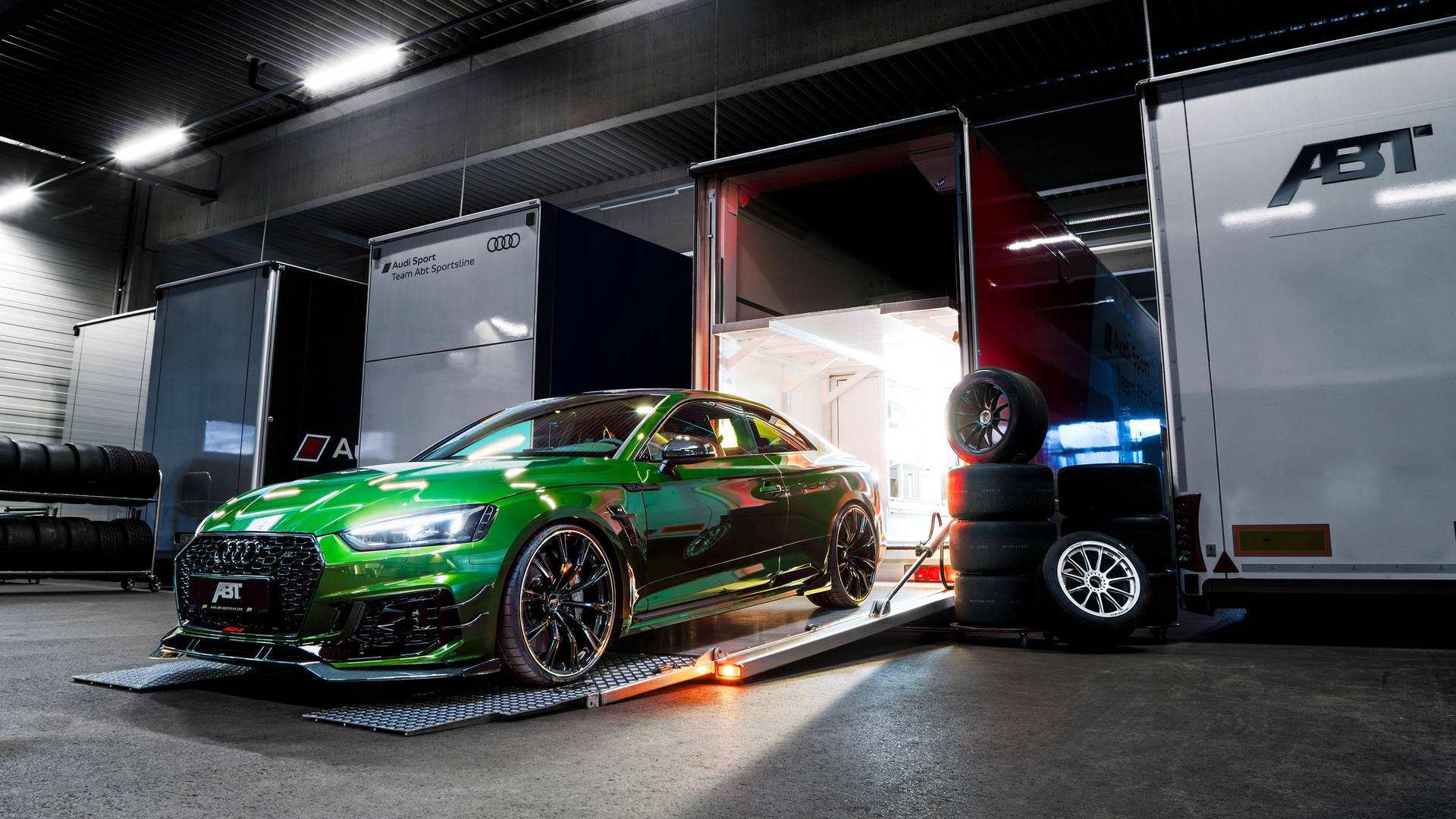 Green Audi Rs Exiting A Truck Background