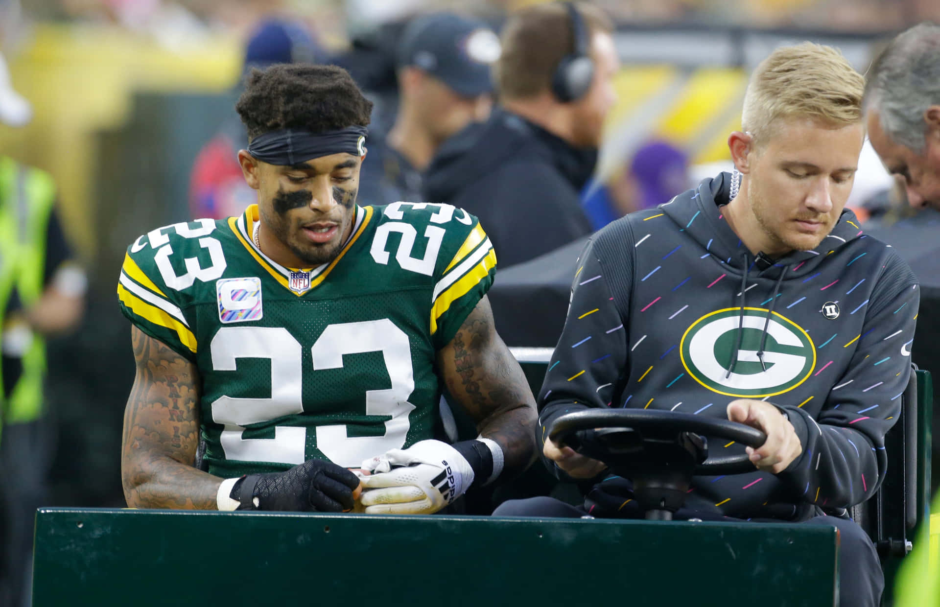 Green Bay Playerand Trainer Sideline Moment Background
