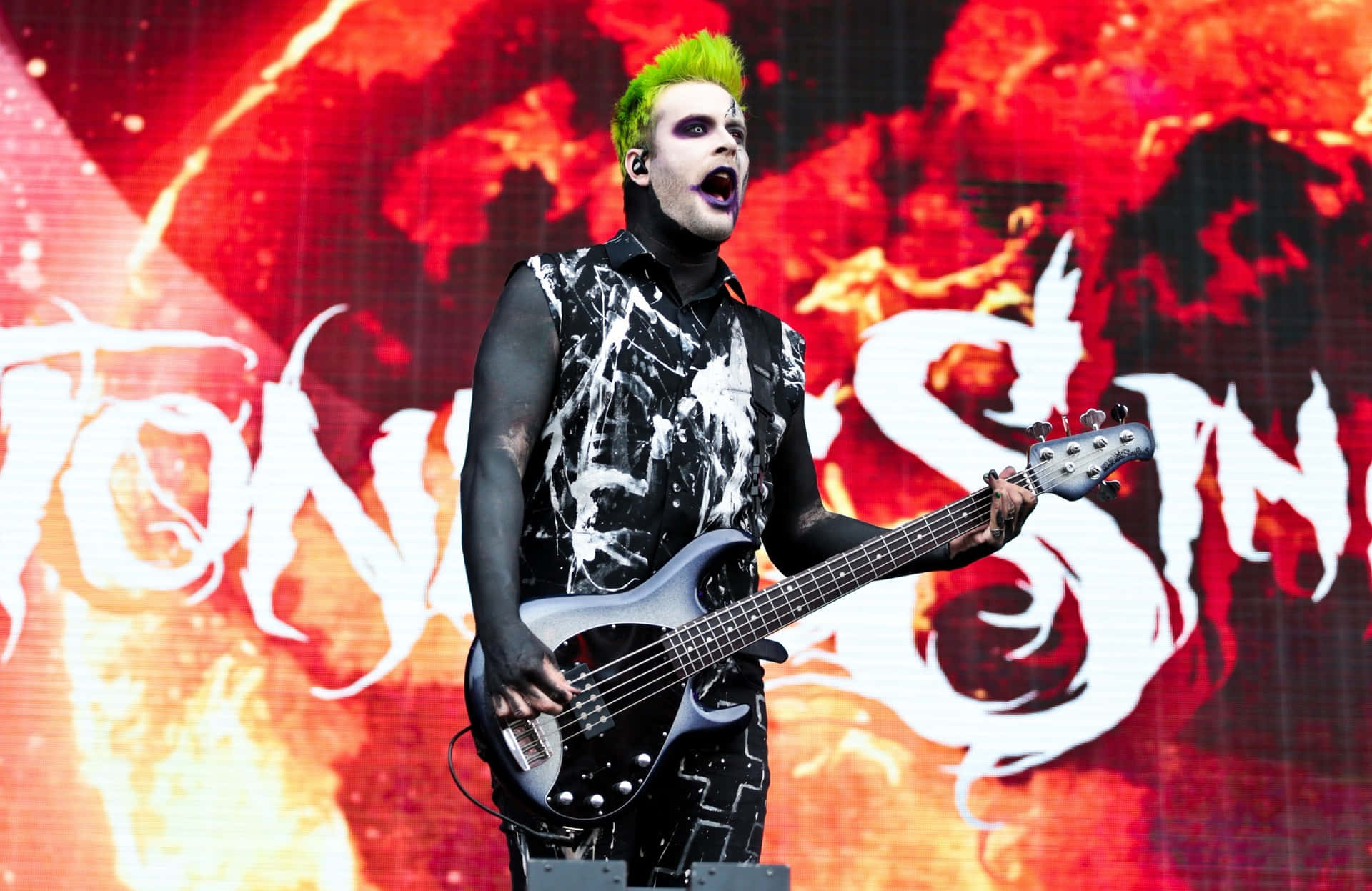 Green Haired Bassist On Stage.jpg Background