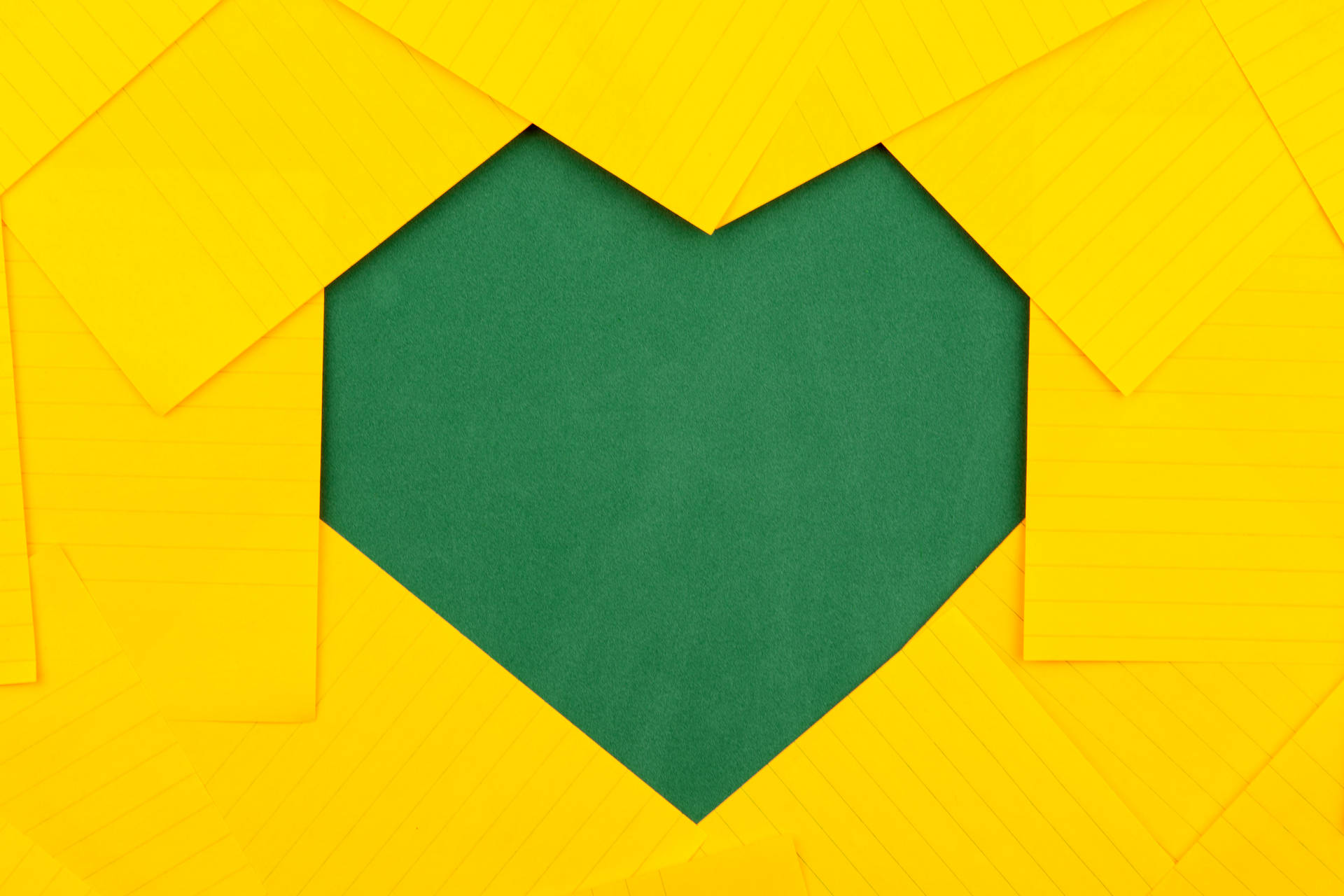 Green Heart On Yellow Paper Background