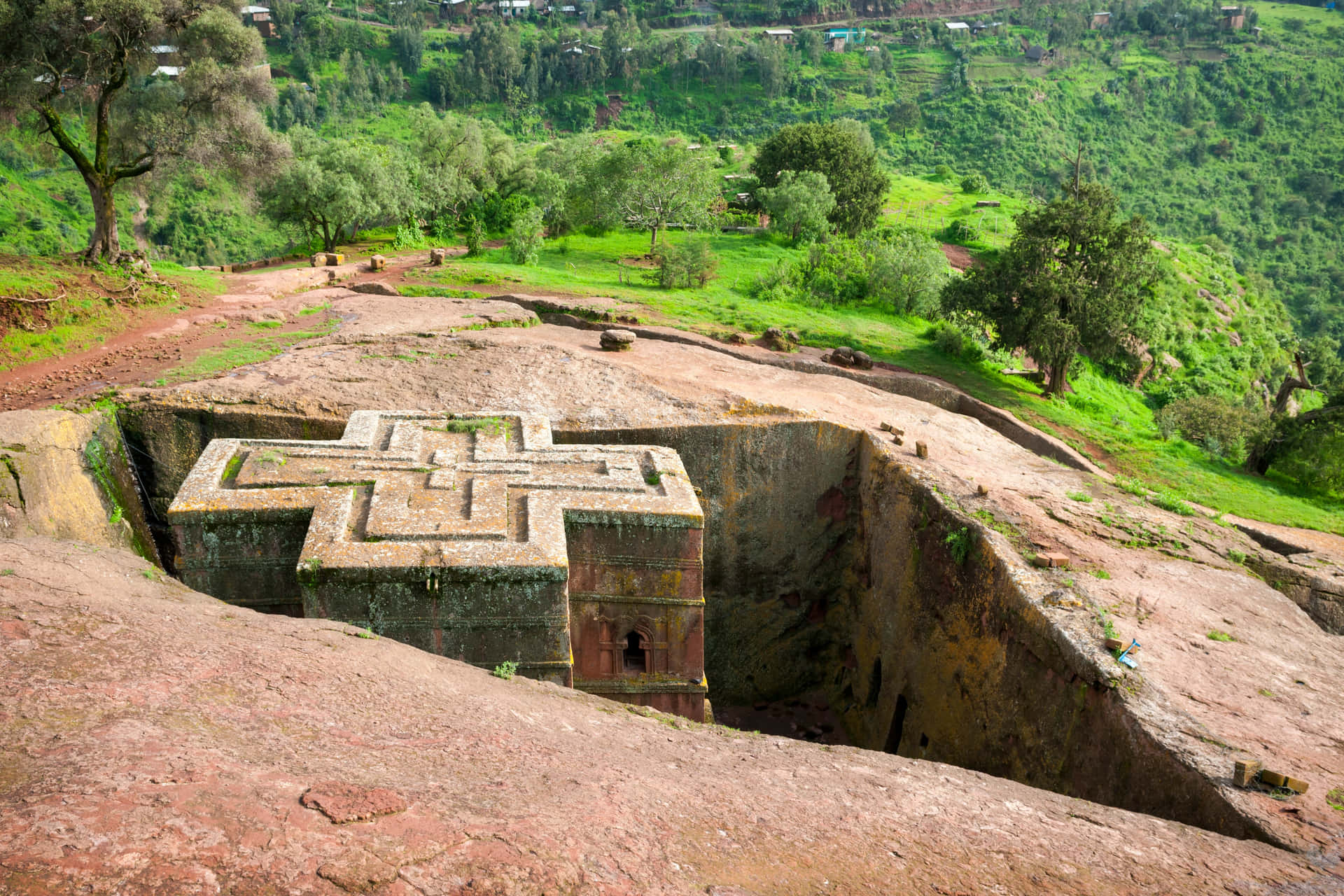Green Hills And Trees Beside Lalibela's St. George Church Background