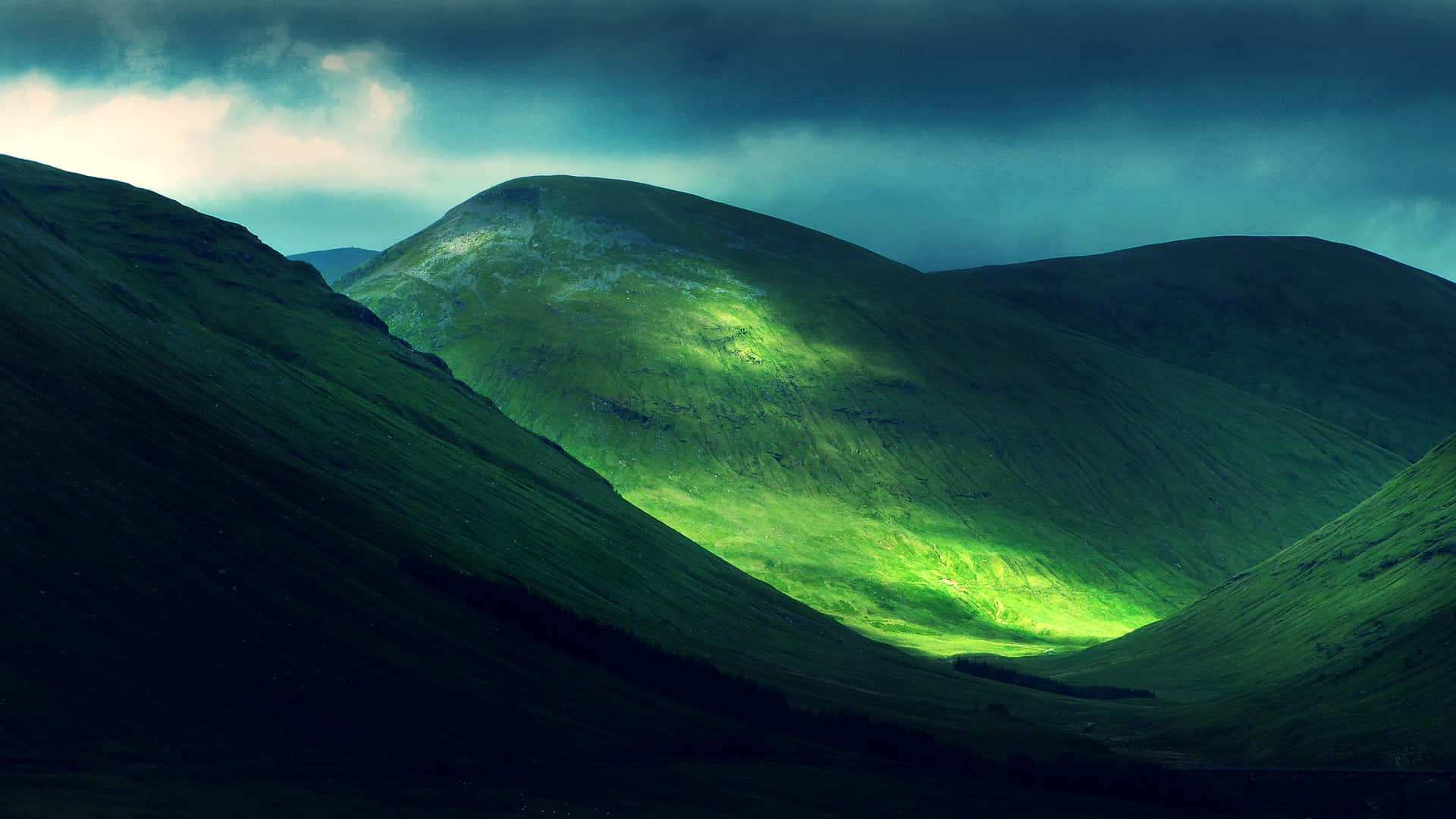 Green Hills Under Dark Clouds Background