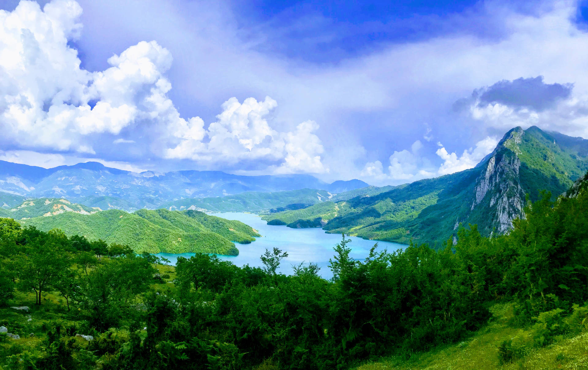 Green Mountains And Azure Lake Background