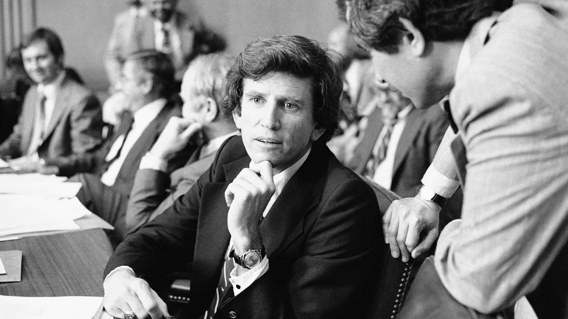 Greyscale Gary Hart Talking To Person Background