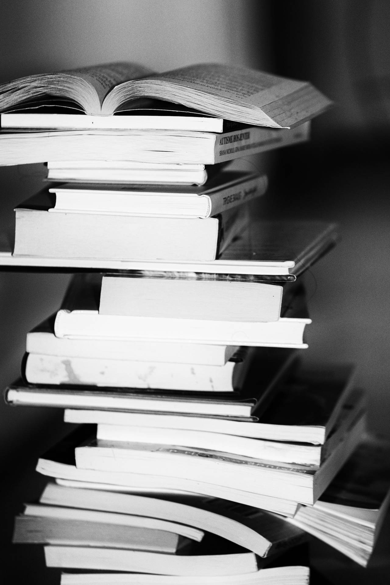 Greyscale Photo Of A Pile Of Books Background