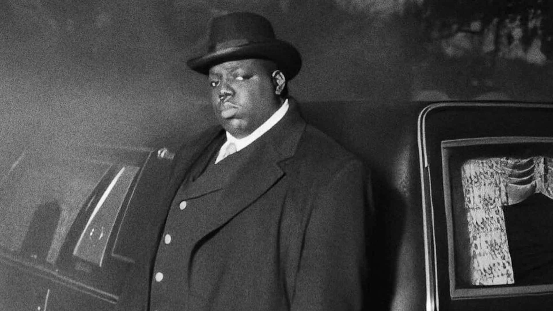 Greyscale The Notorious Big Leaning On Car Background