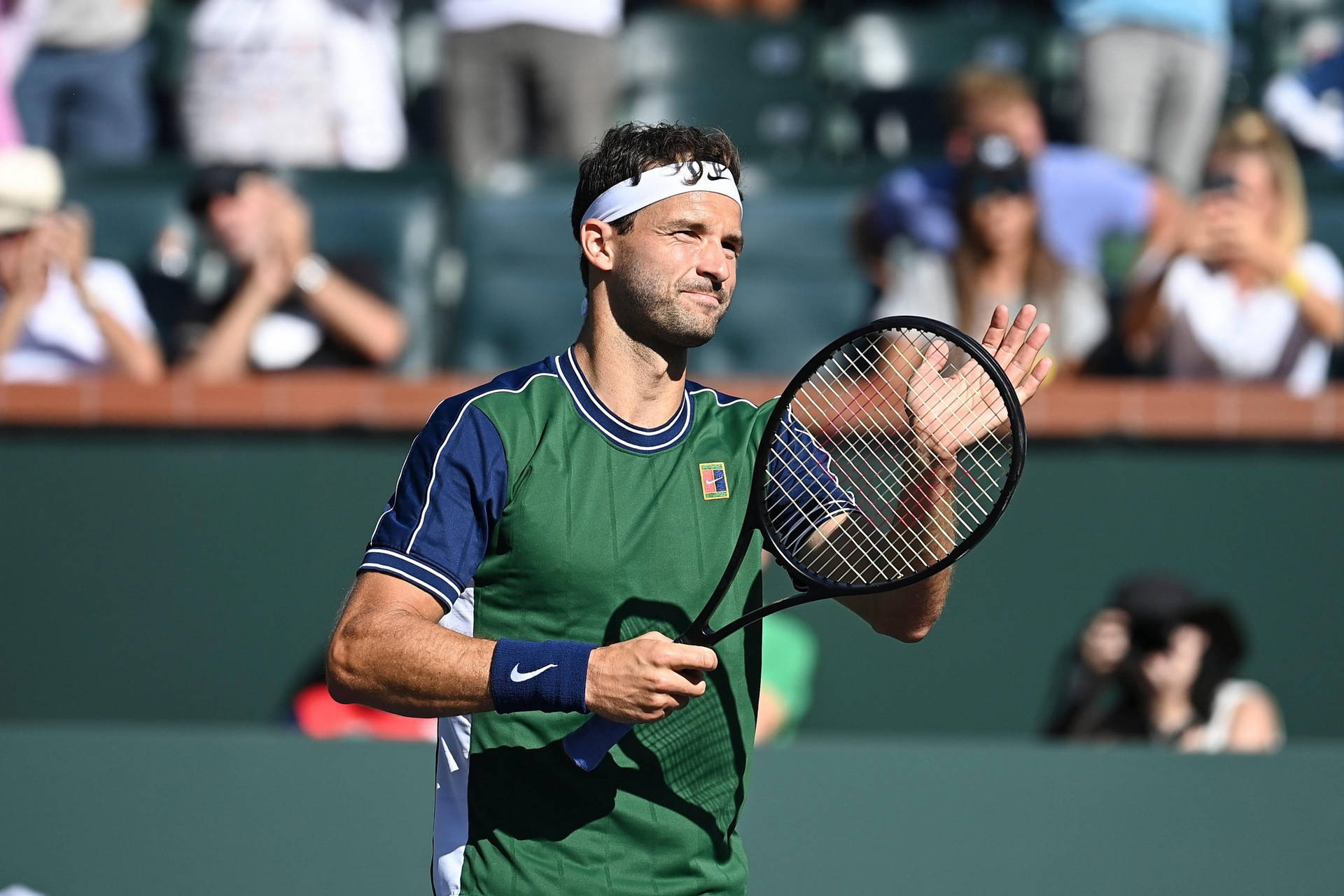 Grigor Dimitrov In Action On A Tennis Court. Background