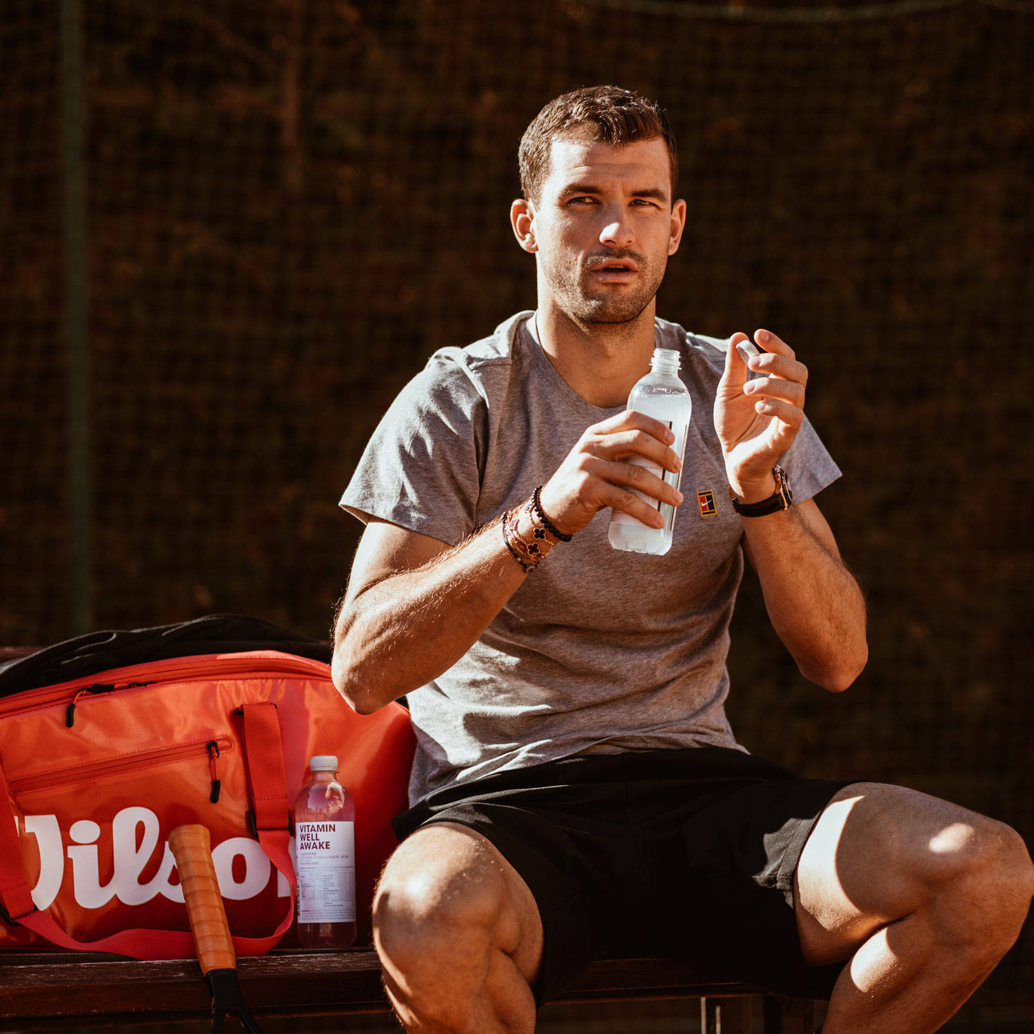 Grigor Dimitrov Sitting With Water Bottle Background