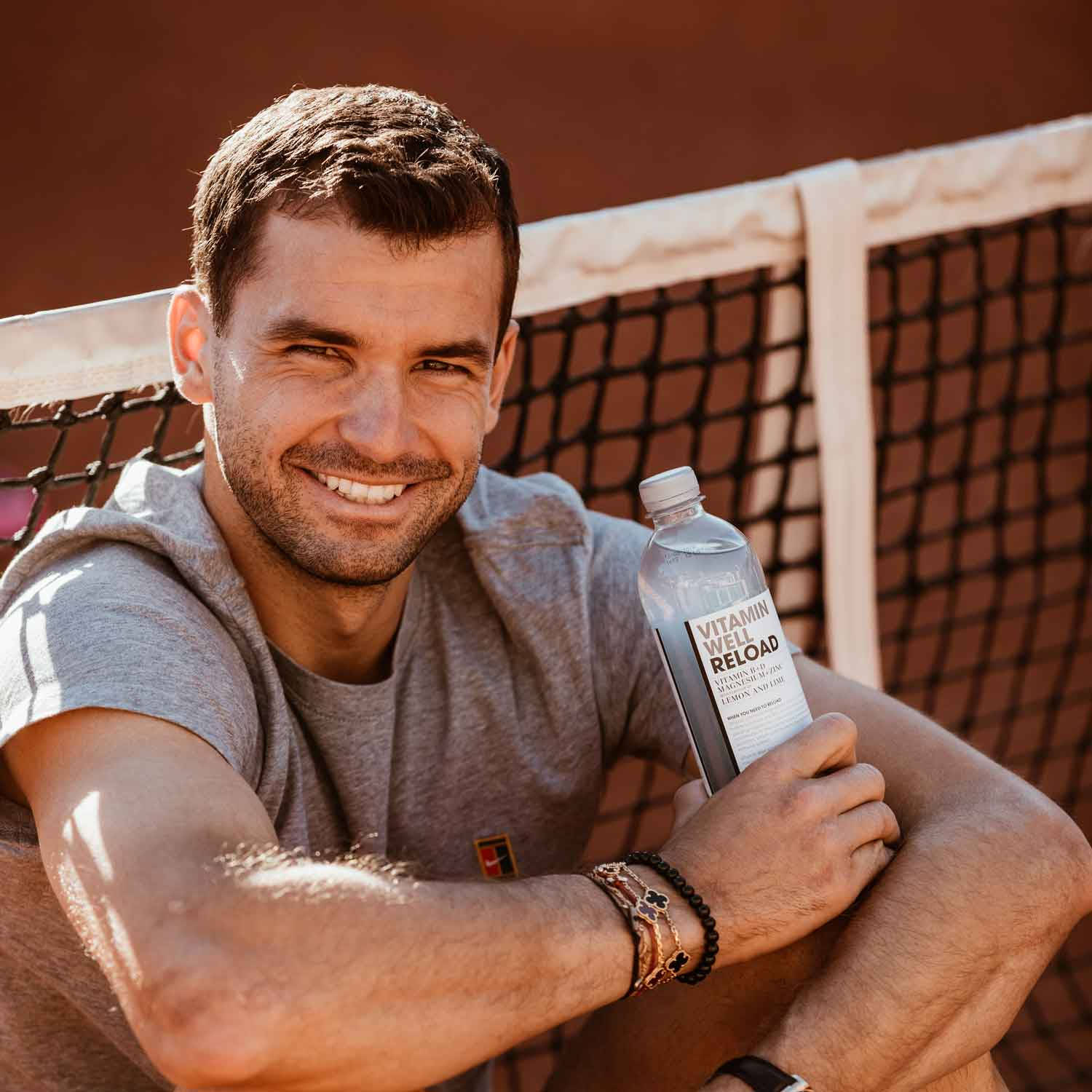 Grigor Dimitrov Smiling With Water Bottle Background