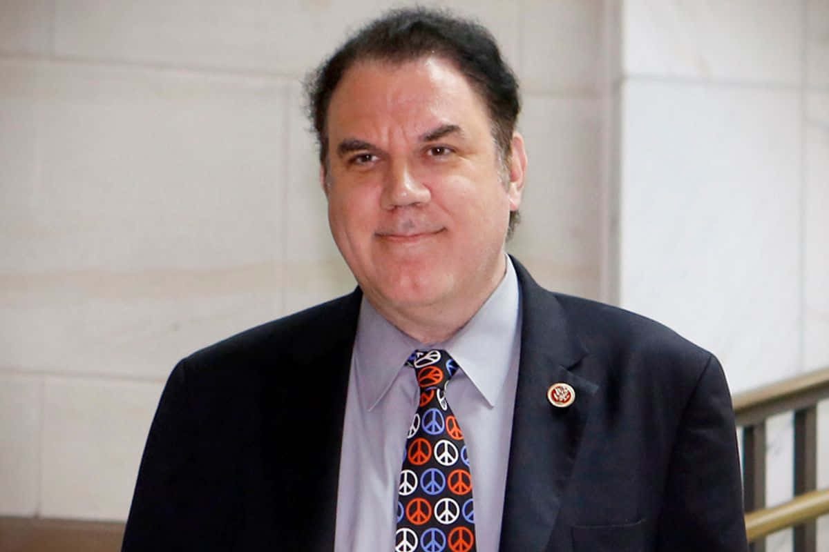 Griining Face Alan Grayson Background