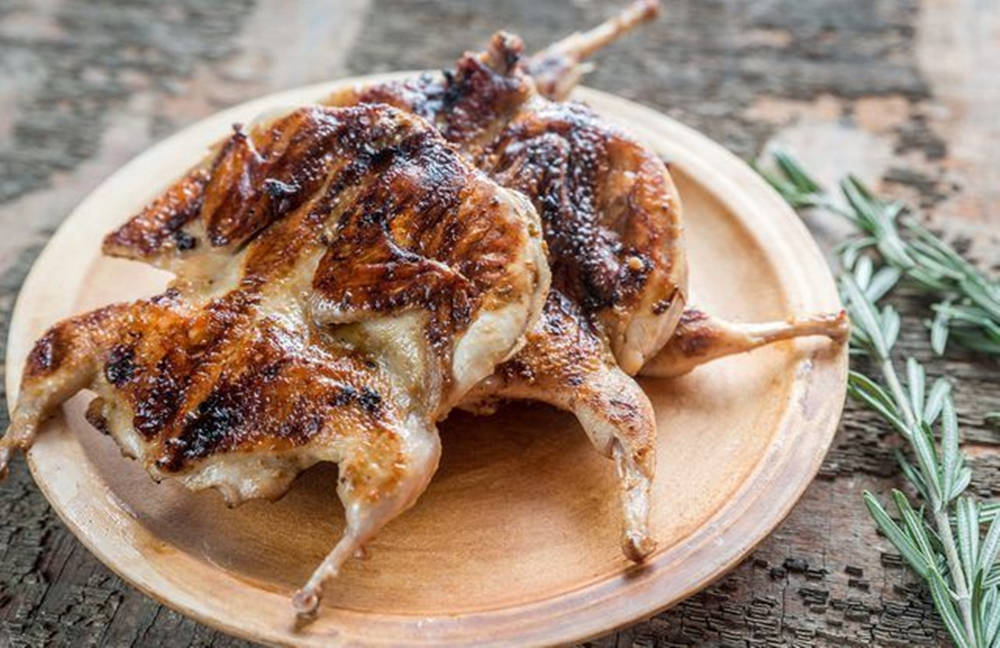 Grilled Quails On Wooden Platter Background