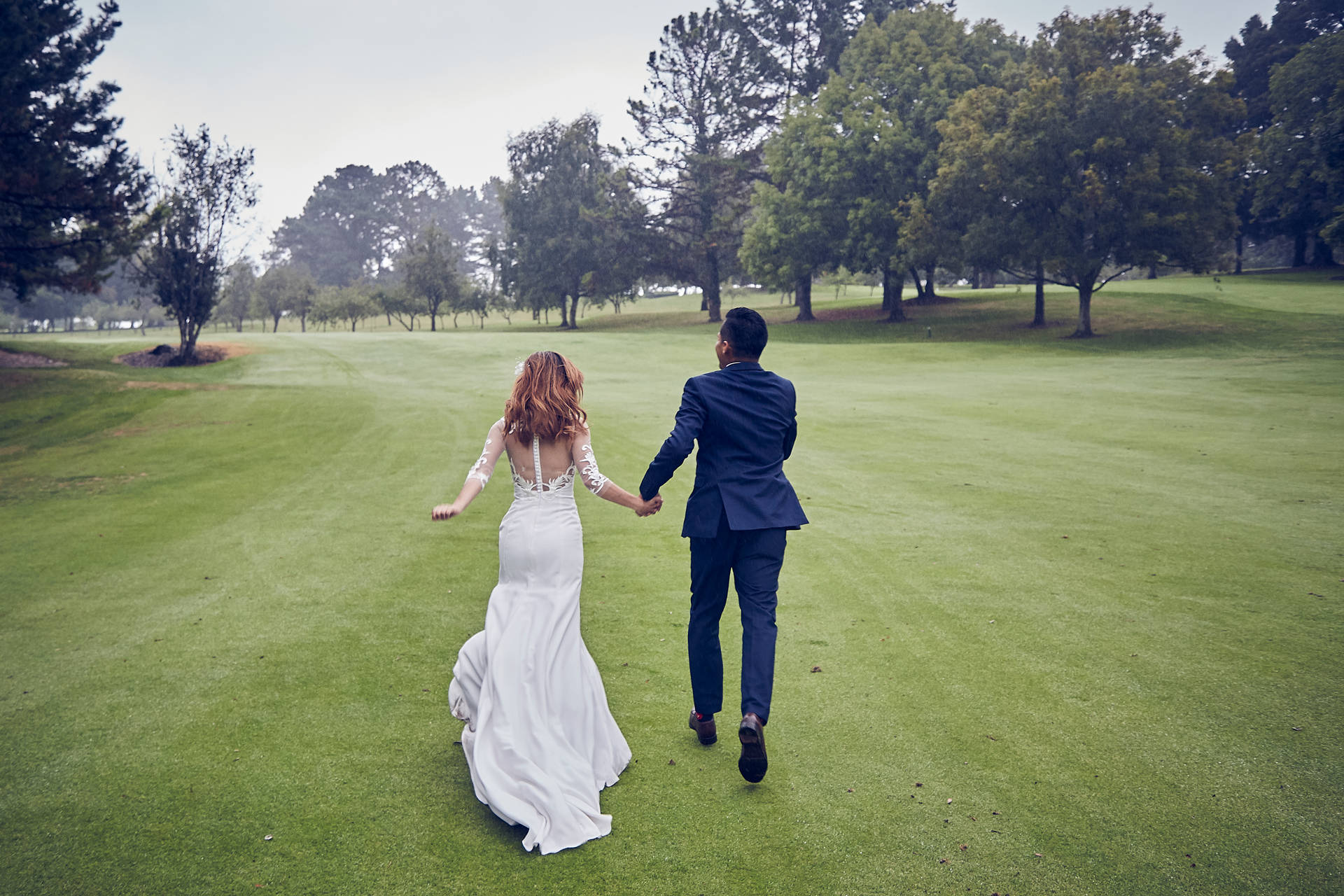 Groom And Bride Running On Golf Course