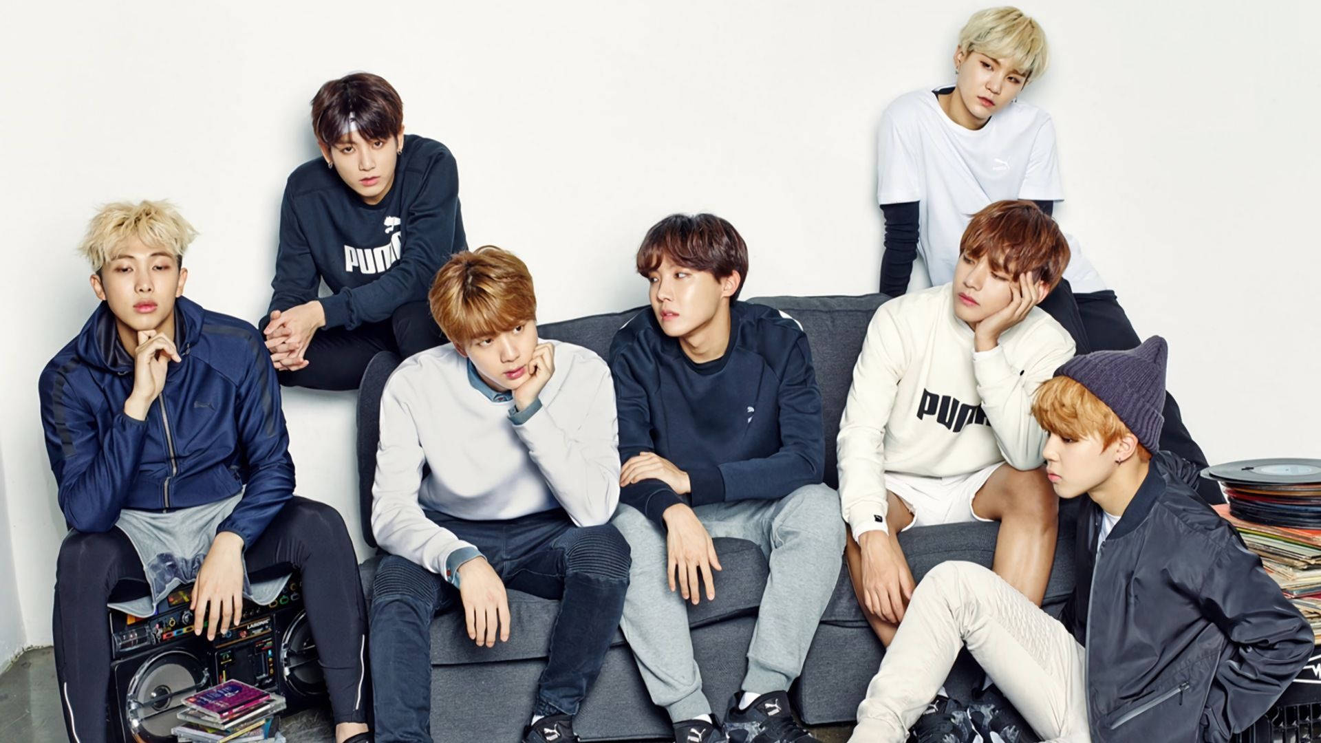 Group Bts On Couch Blue And White Background