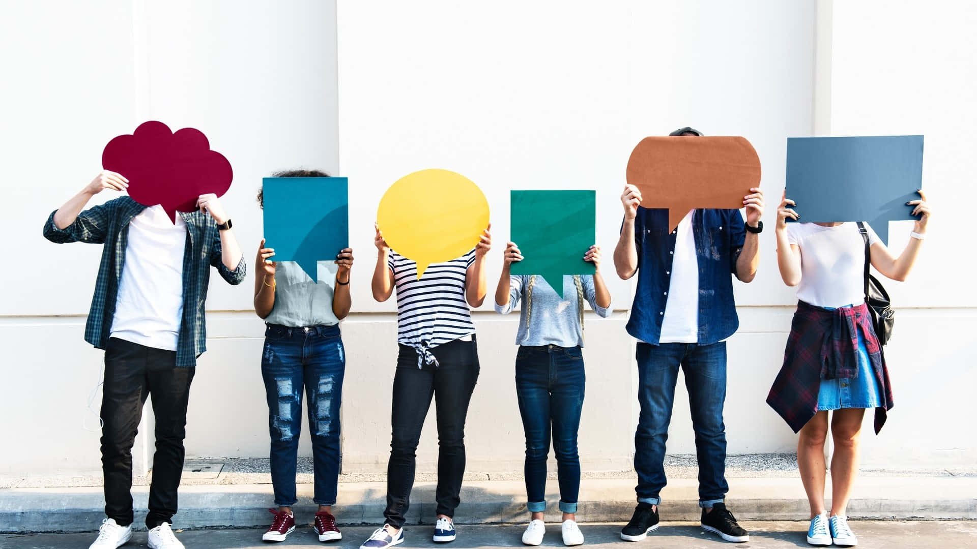 Group Holding Colorful Speech Bubbles Background