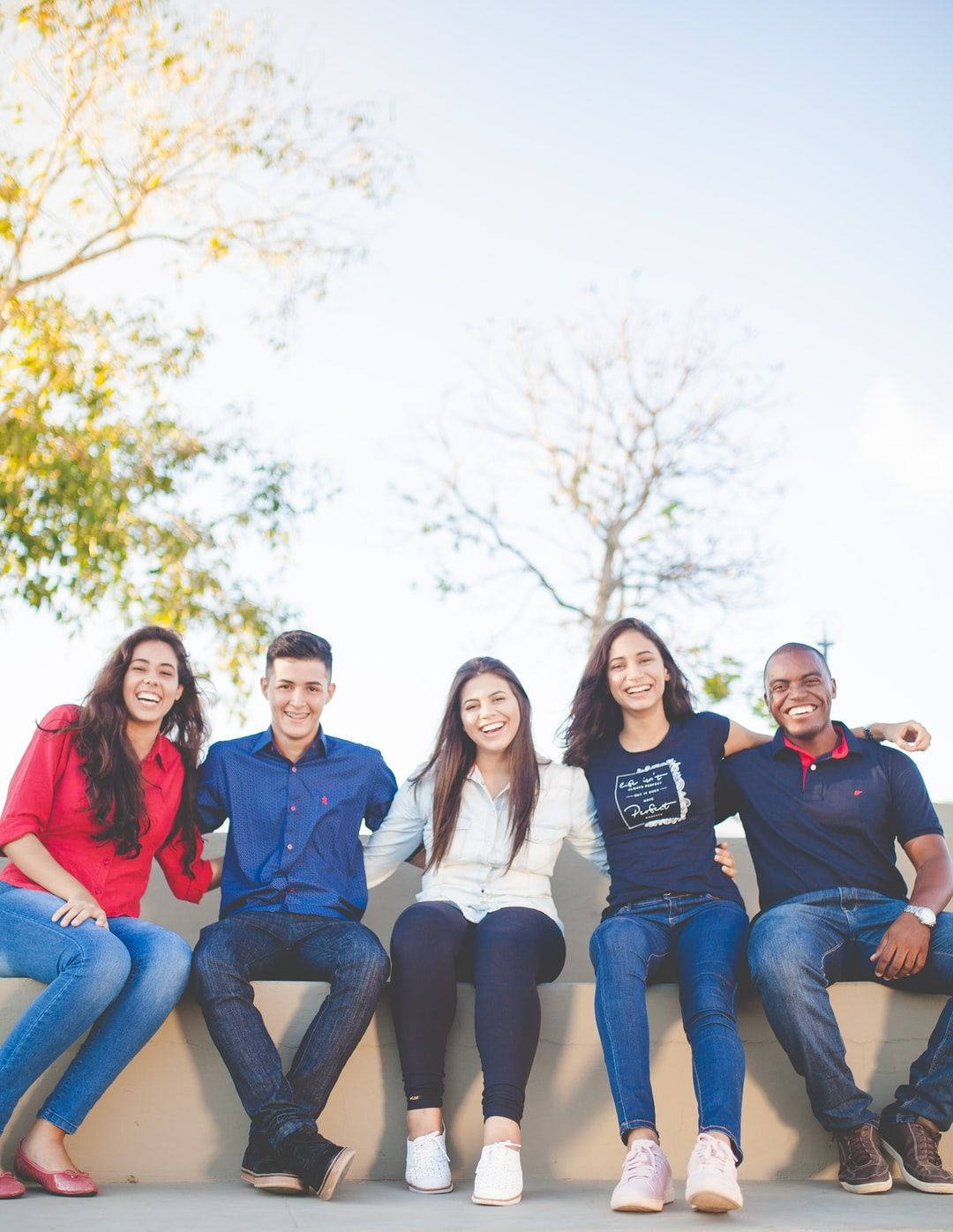 Group Of Friends Seated Together Background