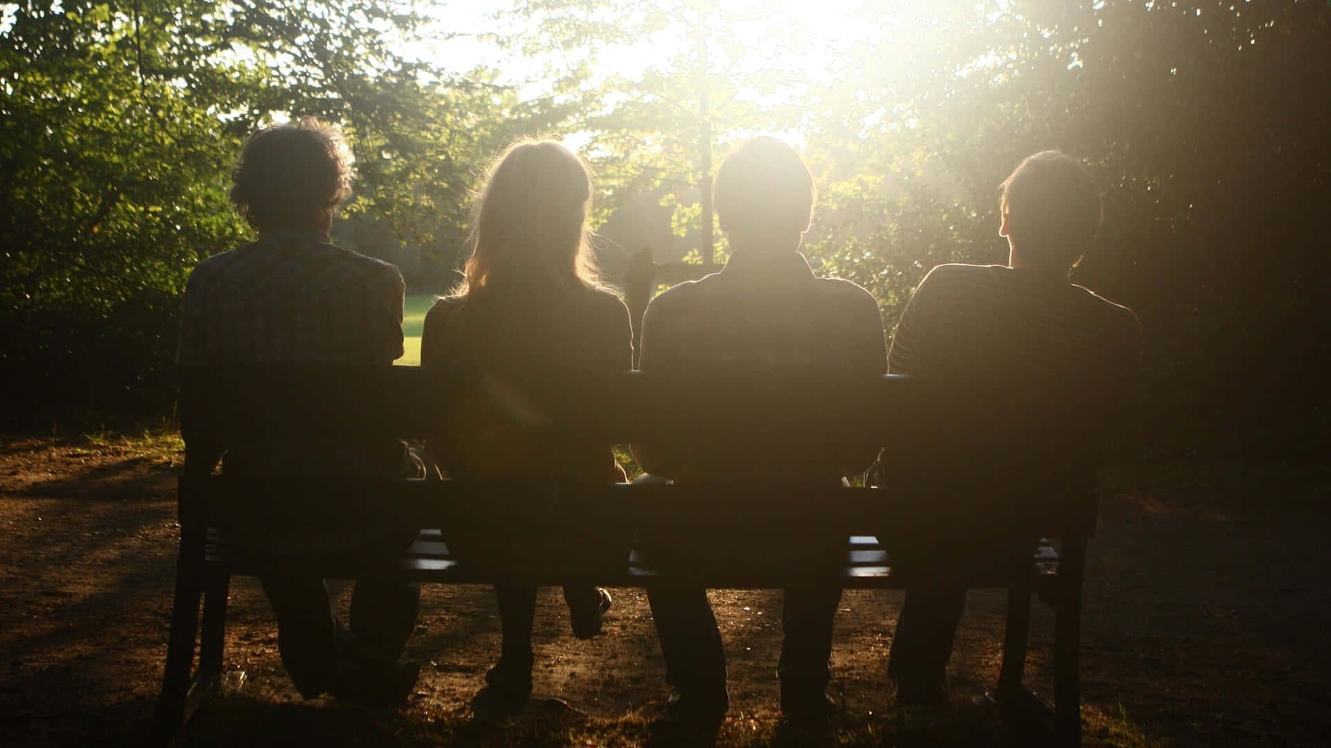 Group Of Friends Sitting On Bench