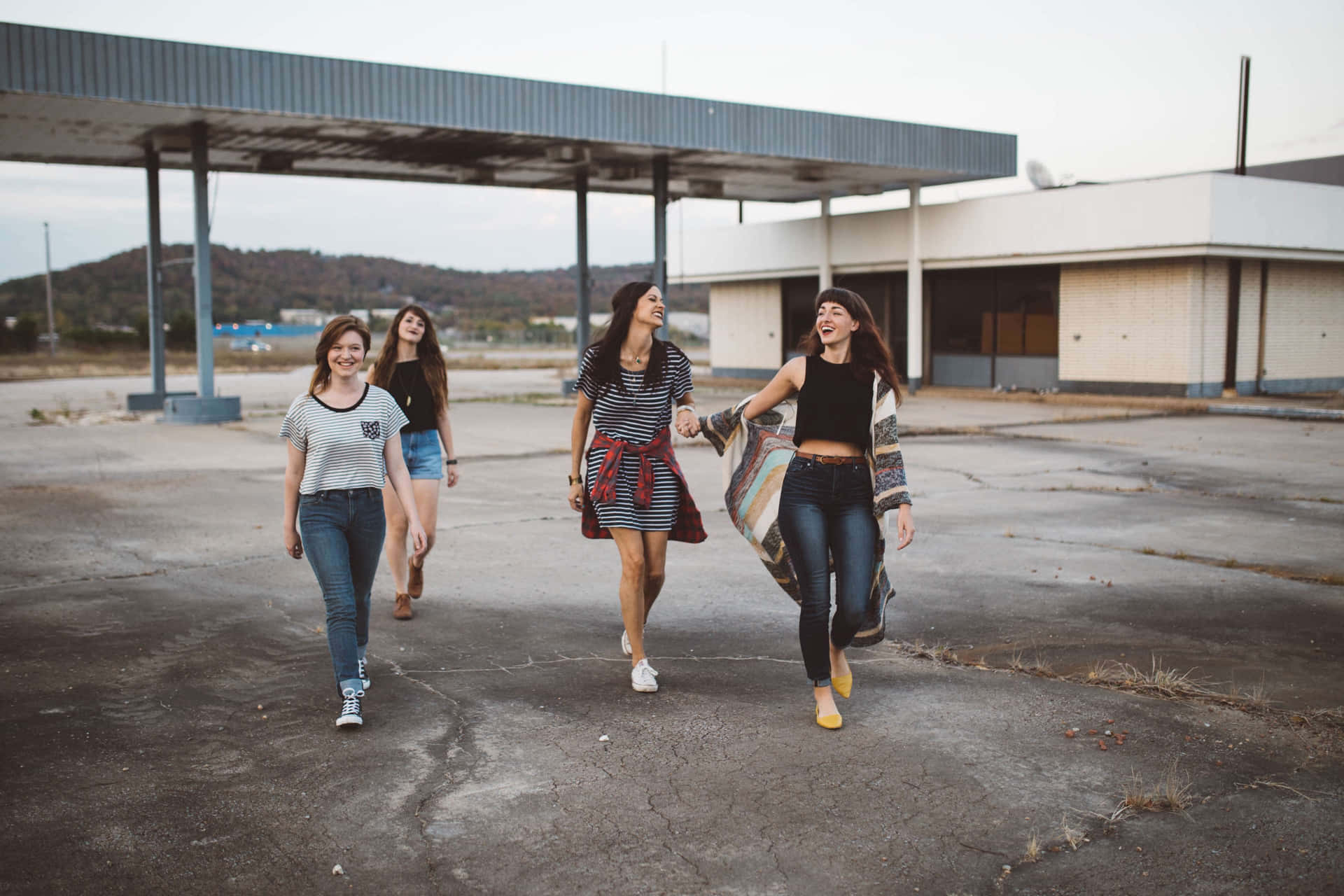 Group Of Friends Walking Away From Old Building