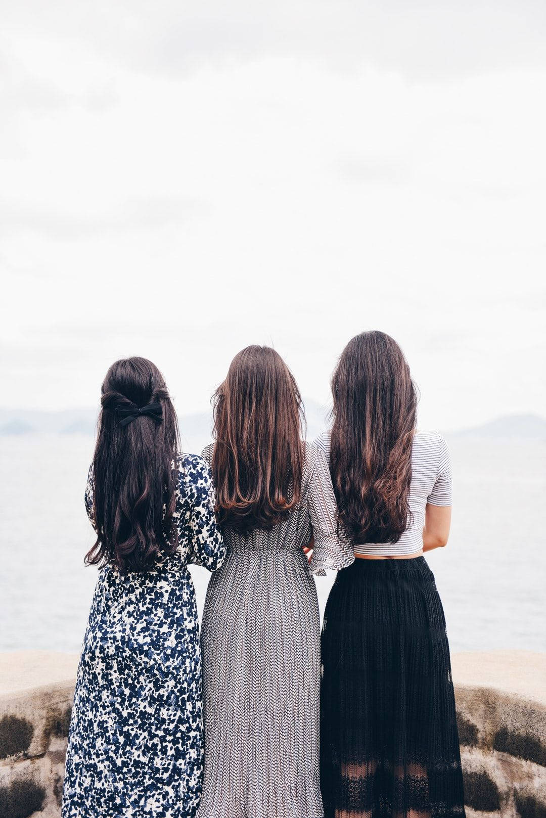 Group Of Girls With Backs Turned Background