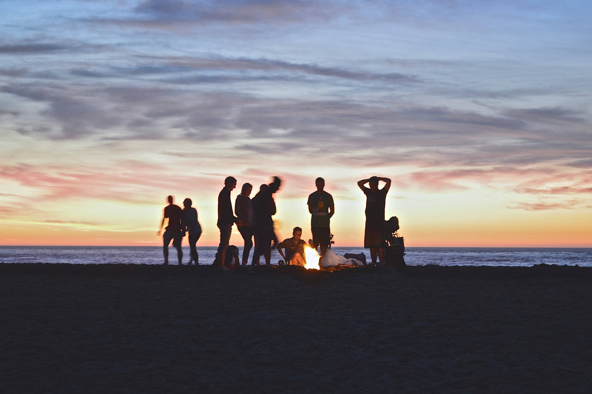 Group Of People Around A Campire Background