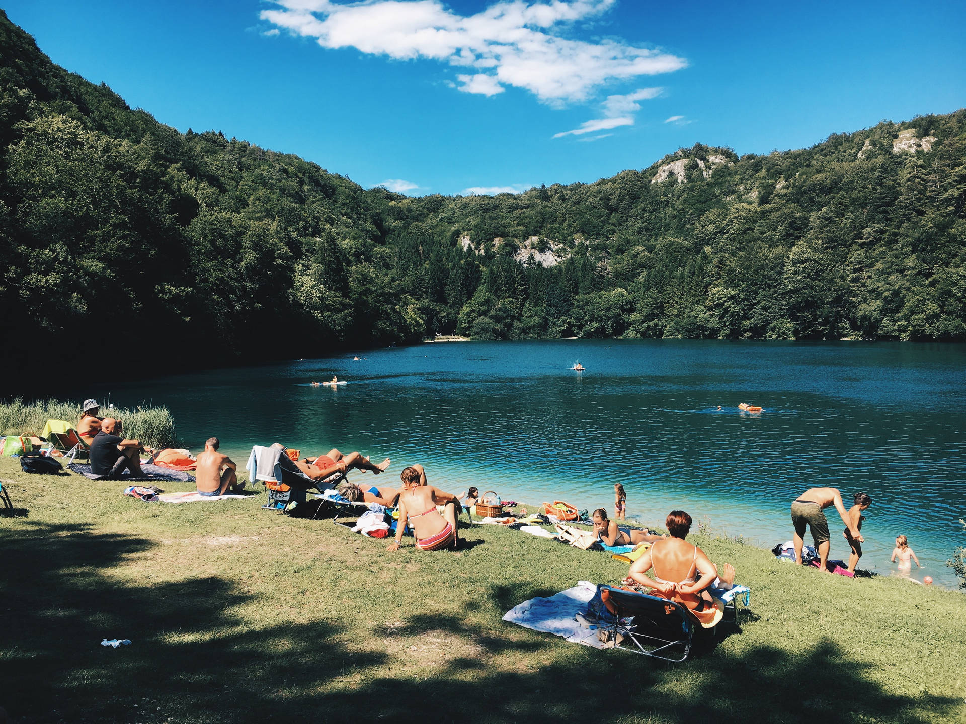 Group Of People By The Lake