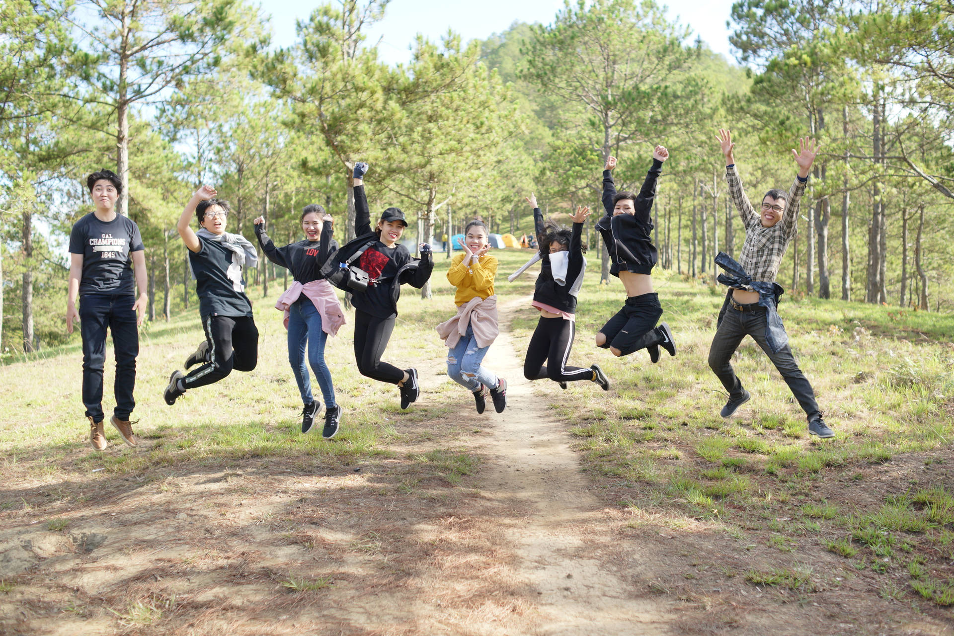 Group Of People Jumping In The Forest