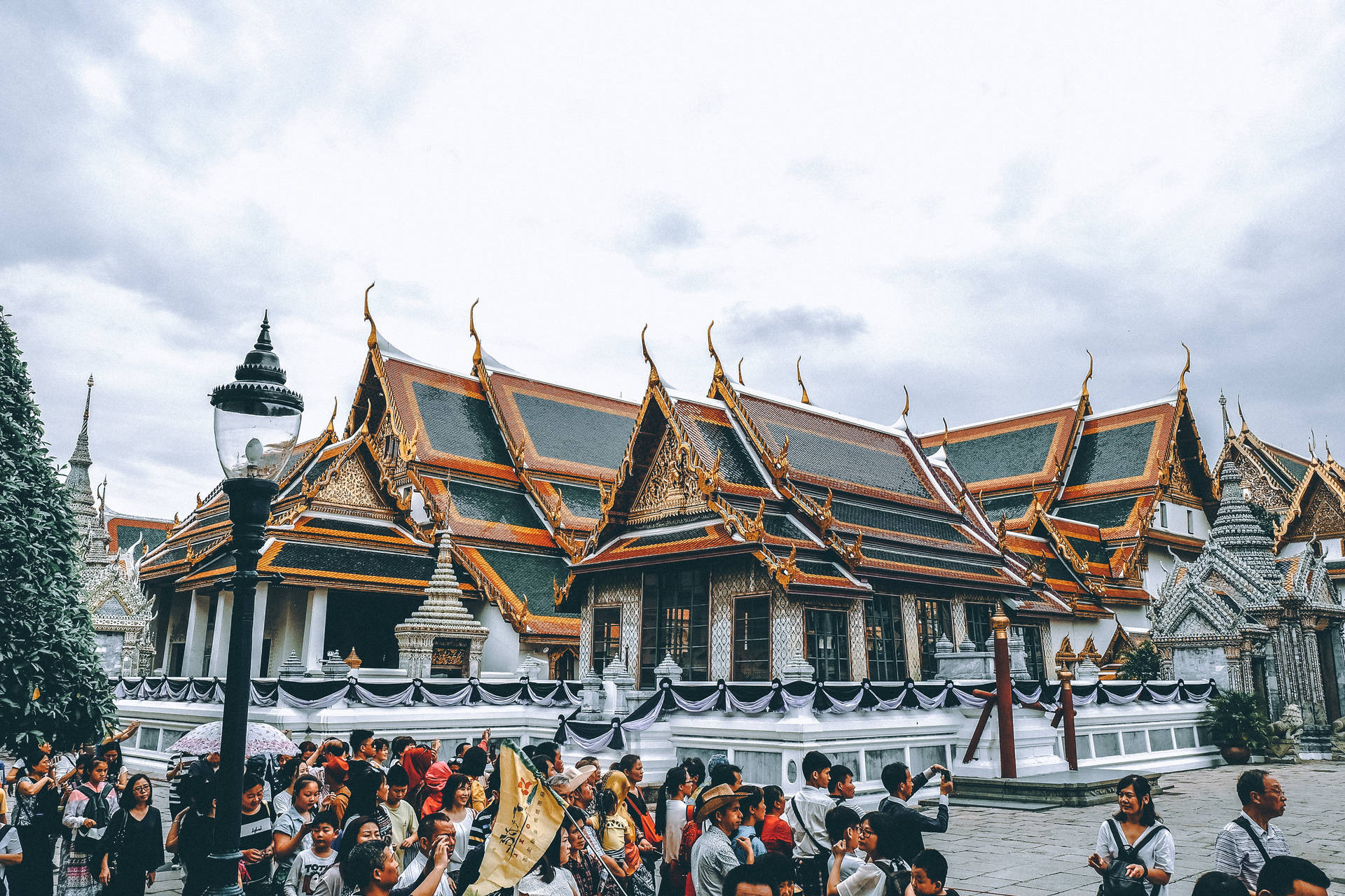 Group Of People Outside A Temple Background