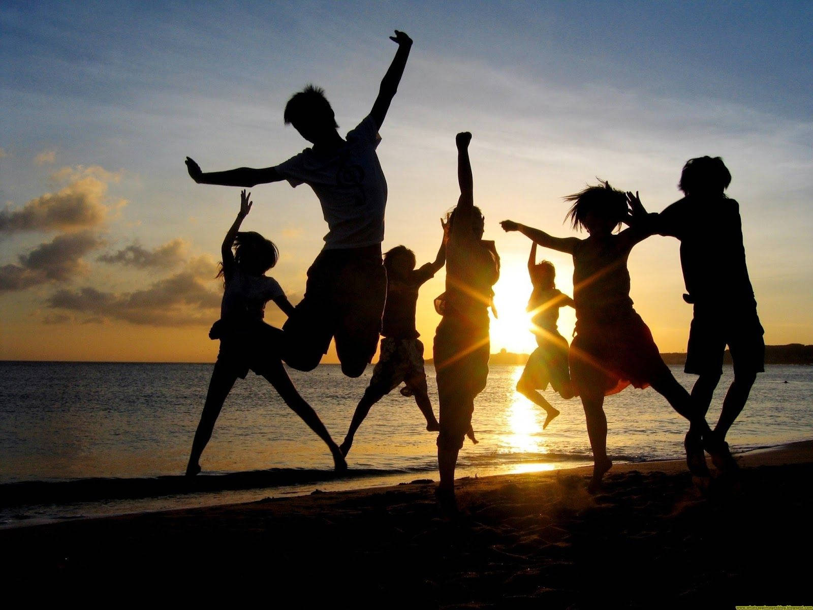 Group Silhouette Jump Shot At Beach Background