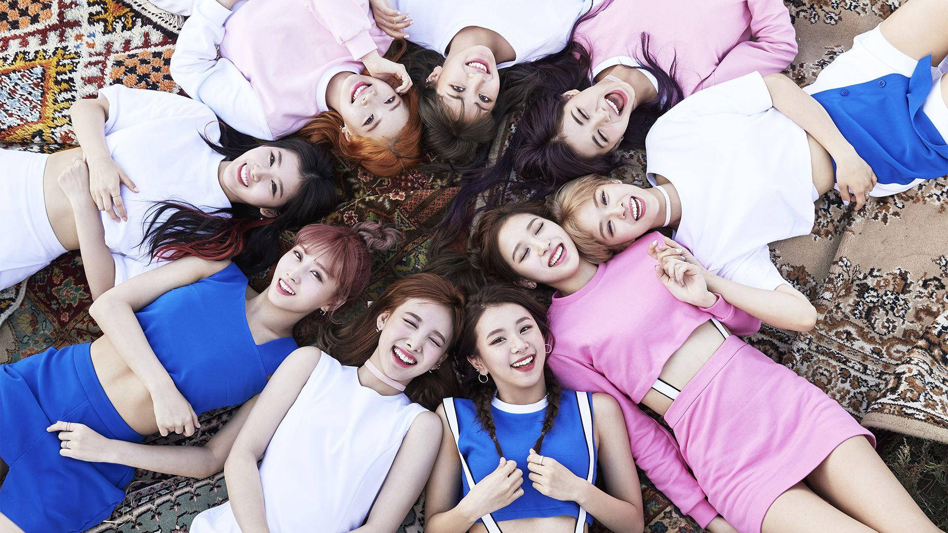 Group Twice Lying On Carpet Background